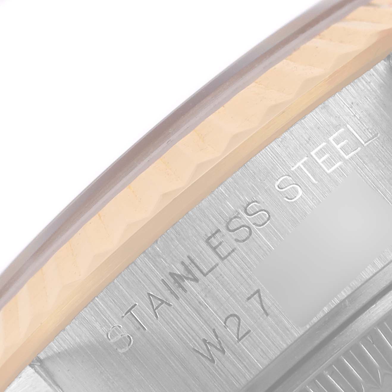 This image shows a close-up view of the case back and bezel area of a Rolex Datejust 69173 Women's Steel and Gold (two tone) Blue Dial 69173 Women's Steel and Gold (two tone) Blue Dial watch, focusing on the stainless steel engraving.