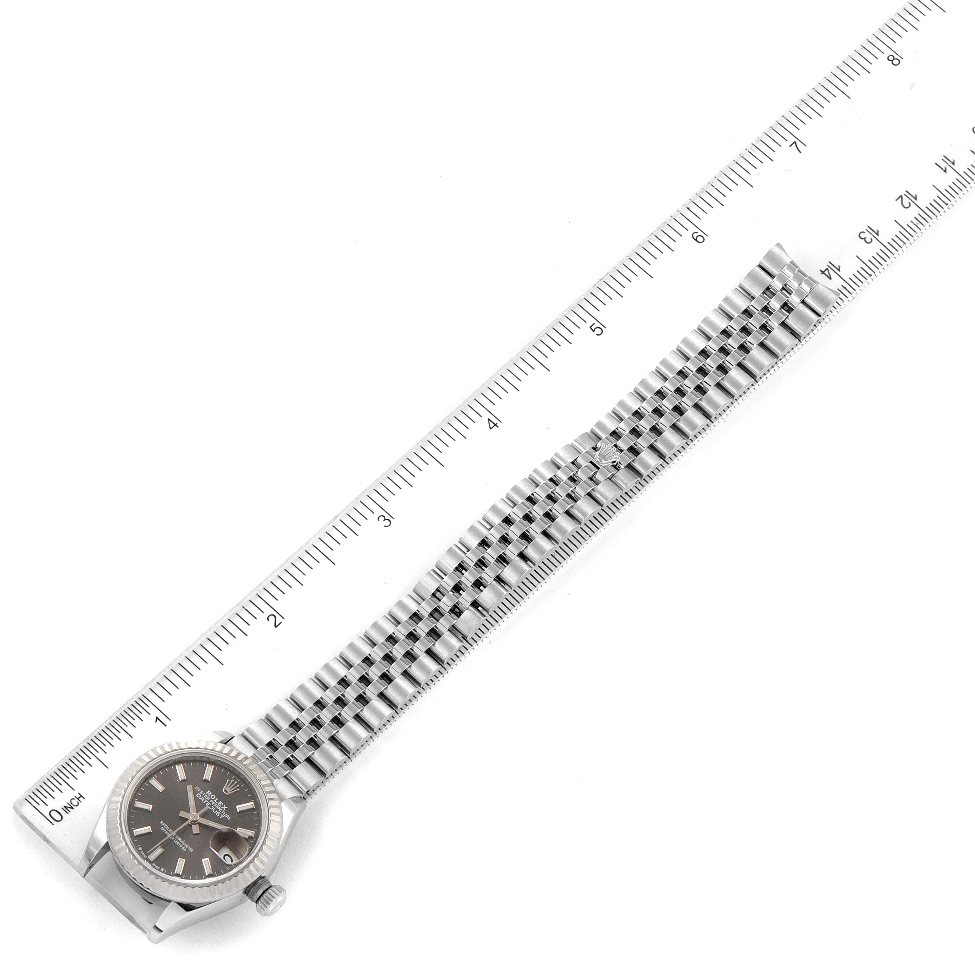This image shows a top-down view of a Rolex Datejust 279174 Women's Stainless Steel Grey Dial 279174 Women's Stainless Steel Grey Dial watch with its full bracelet next to a ruler for measurement.