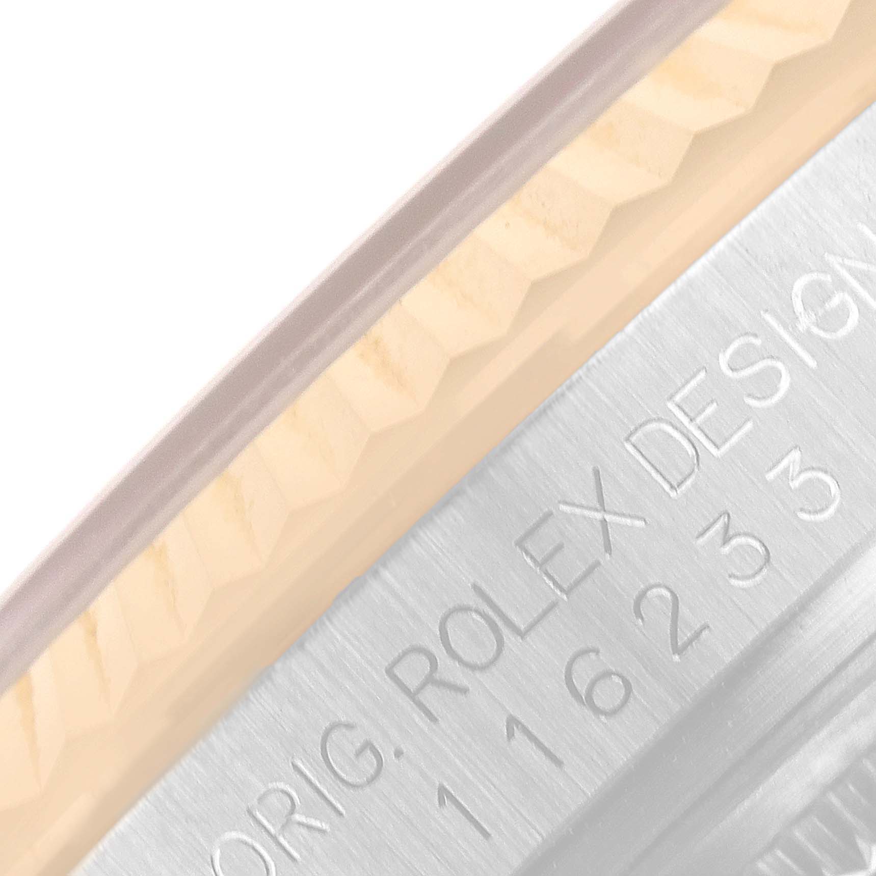 The image shows a close-up of the edge and engraved details on the case of a Rolex Datejust 116233 Men's Steel and Gold (two tone) Champagne Dial 116233 Men's Steel and Gold (two tone) Champagne Dial model watch.