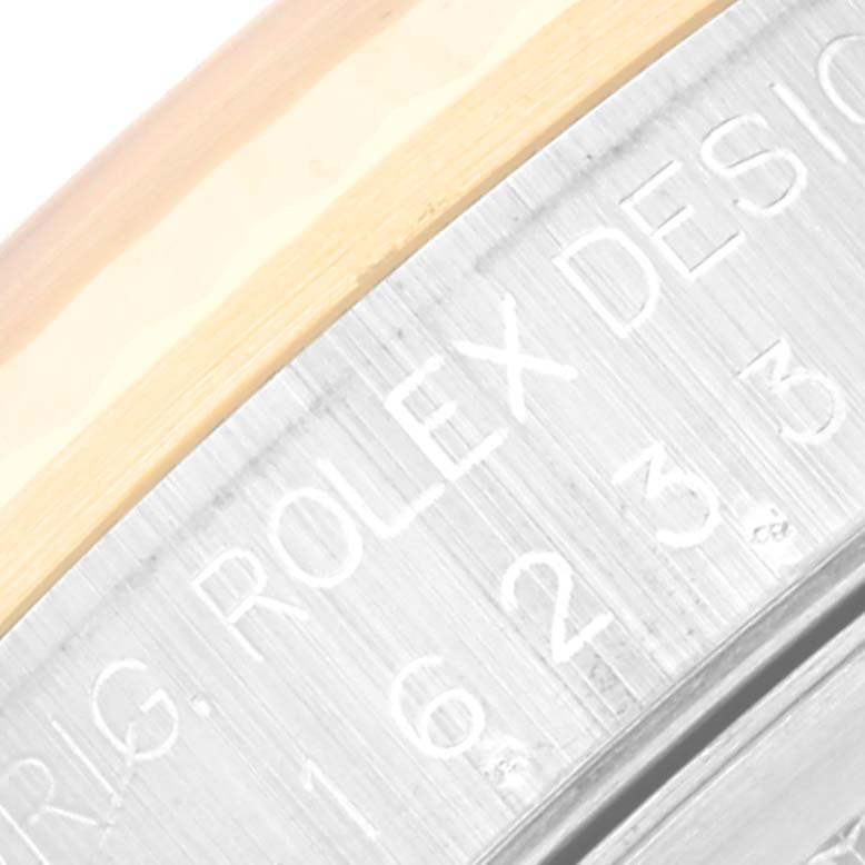 This is a close-up image focusing on the engraved details on the bezel of a Rolex Datejust 16233 Men's Steel and Gold (two tone) Champagne Dial 16233 Men's Steel and Gold (two tone) Champagne Dial watch.