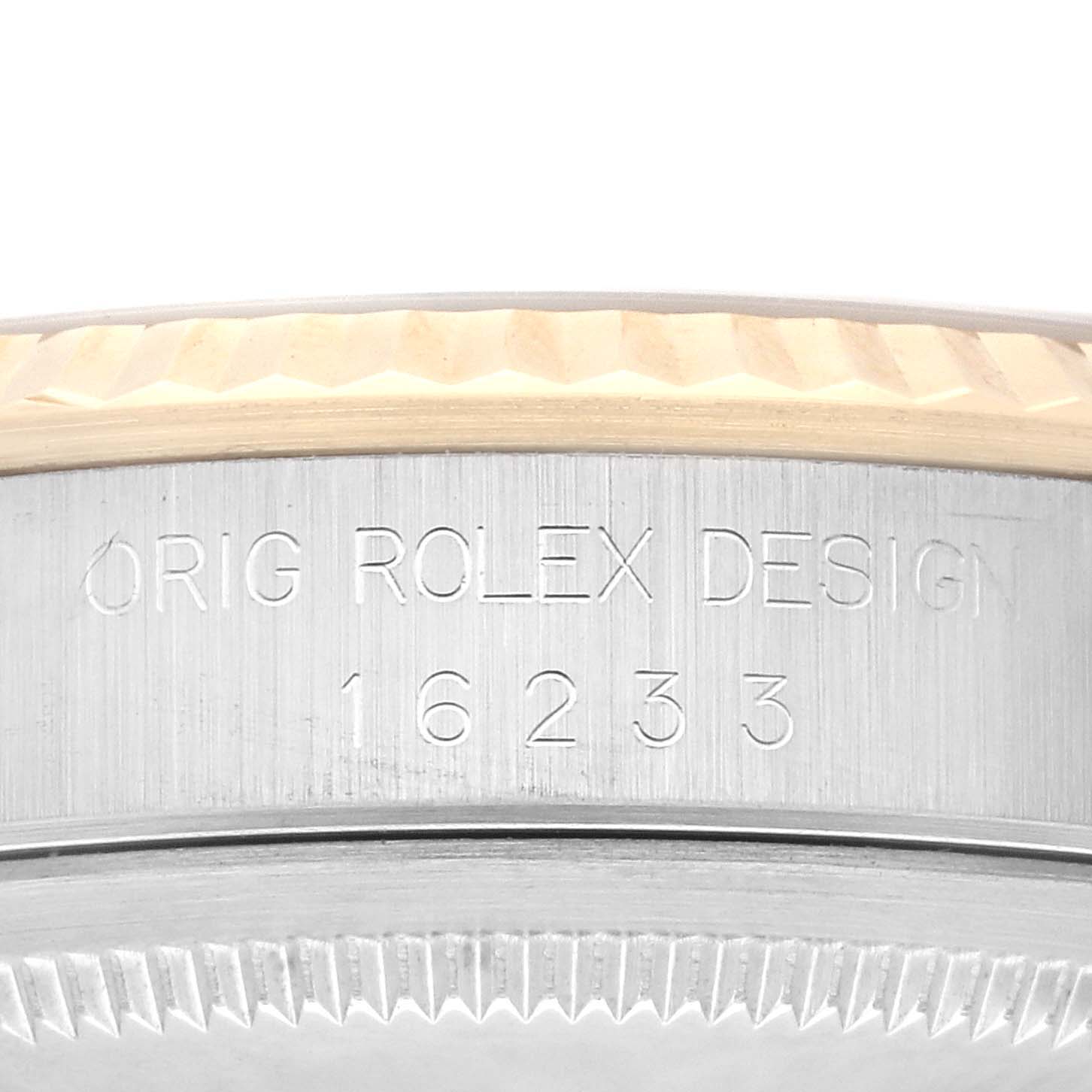 This image shows a close-up of the side engraving on a Rolex Datejust 16233 Men's Steel and Gold (two tone) Champagne Dial 16233 Men's Steel and Gold (two tone) Champagne Dial model, highlighting "ORIG ROLEX DESIGN" and the number 16233.