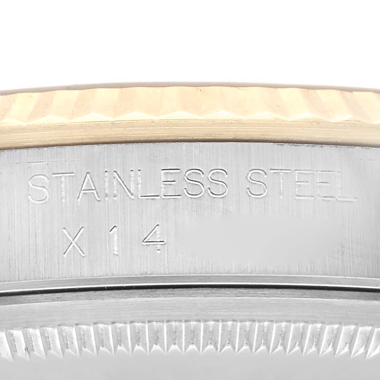 This image shows a close-up view of the bezel and part of the case back of a Rolex Datejust 16233 Men's Steel and Gold (two tone) Champagne Dial 16233 Men's Steel and Gold (two tone) Champagne Dial watch with "STAINLESS STEEL" engraved.