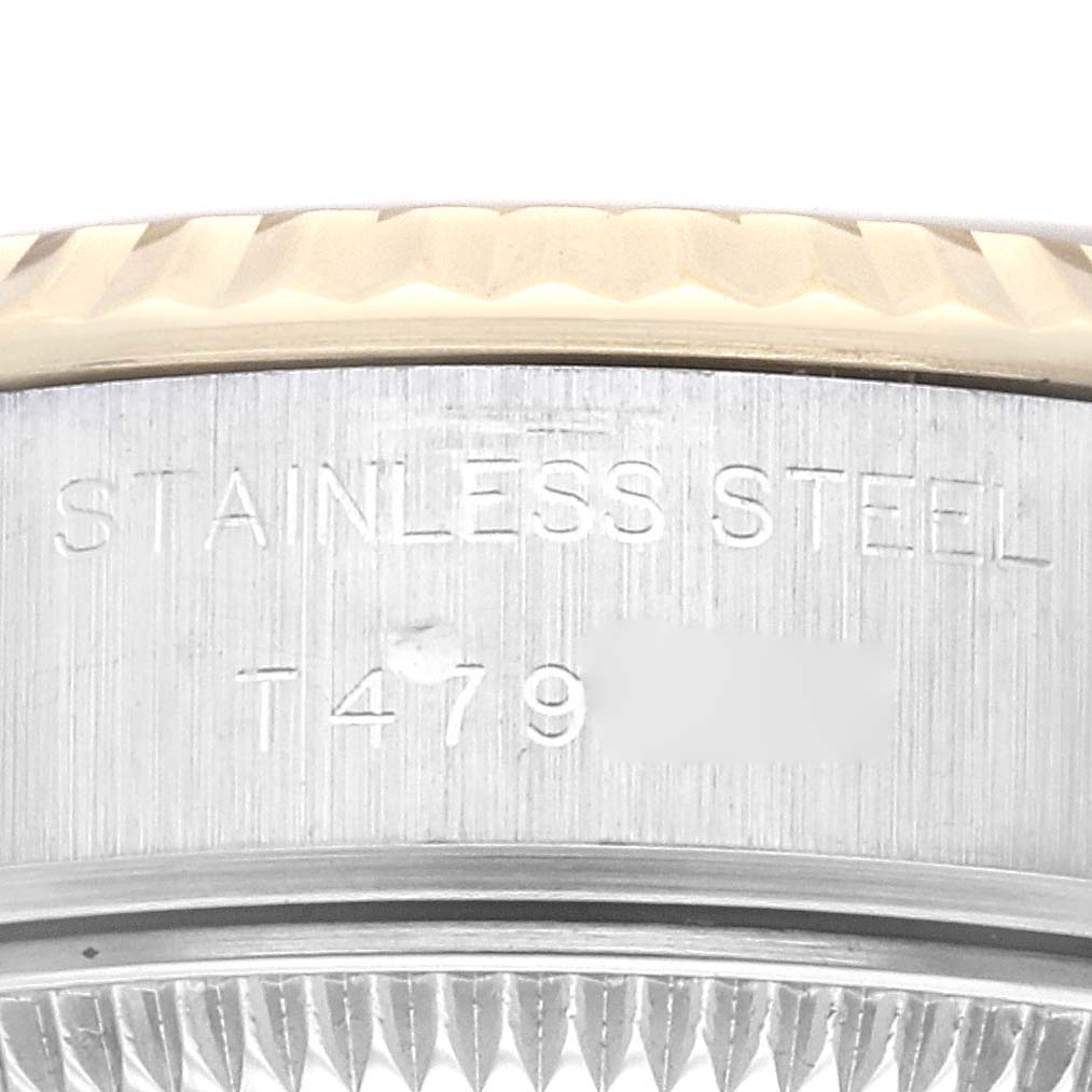 The image shows a close-up of the side of a Rolex Datejust 69173 Women's Steel and Gold (two tone) Champagne Dial 69173 Women's Steel and Gold (two tone) Champagne Dial watch case, displaying the "STAINLESS STEEL" engraved label.