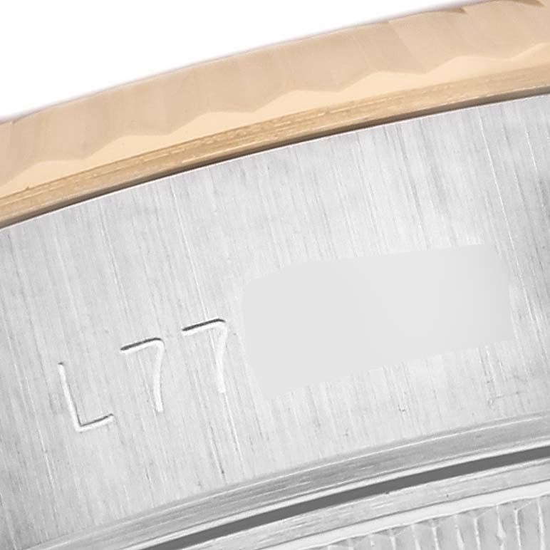 This close-up image of the Rolex Datejust 69173 Women's Steel and Gold (two tone) Champagne Dial 69173 Women's Steel and Gold (two tone) Champagne Dial model shows the engraved serial number on the watch's side case.
