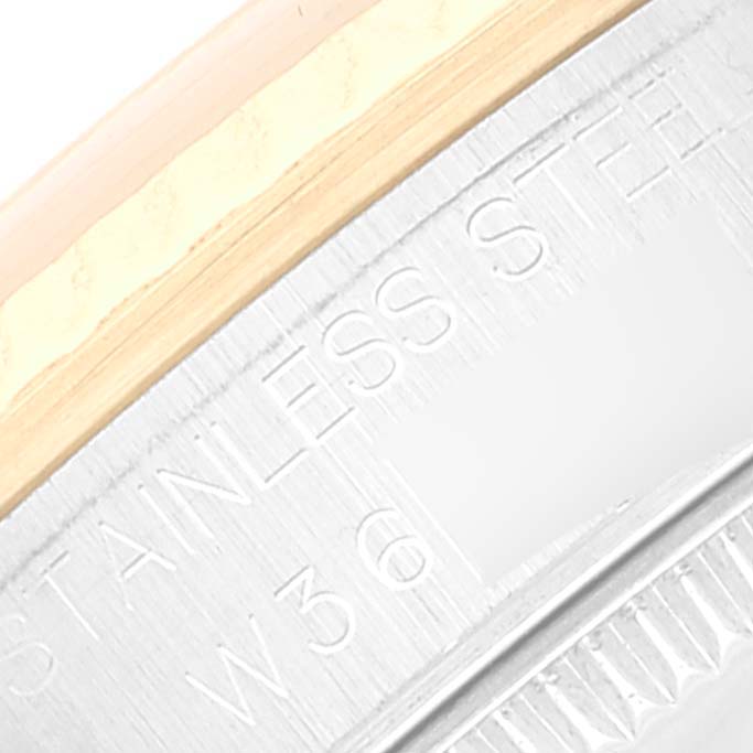 This image shows a close-up of the outer edge and engraved text of a Rolex Mid-Size 68273 Women's Steel and Gold (two tone) Silver Dial 68273 Women's Steel and Gold (two tone) Silver Dial watch.