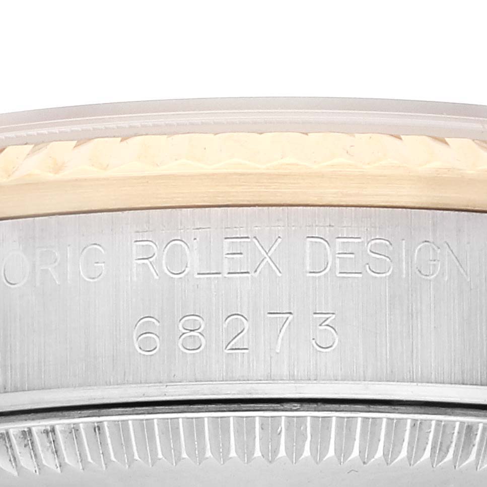 The image shows a close-up of the side of the Mid-Size Rolex model 68273 with the serial number engraved.