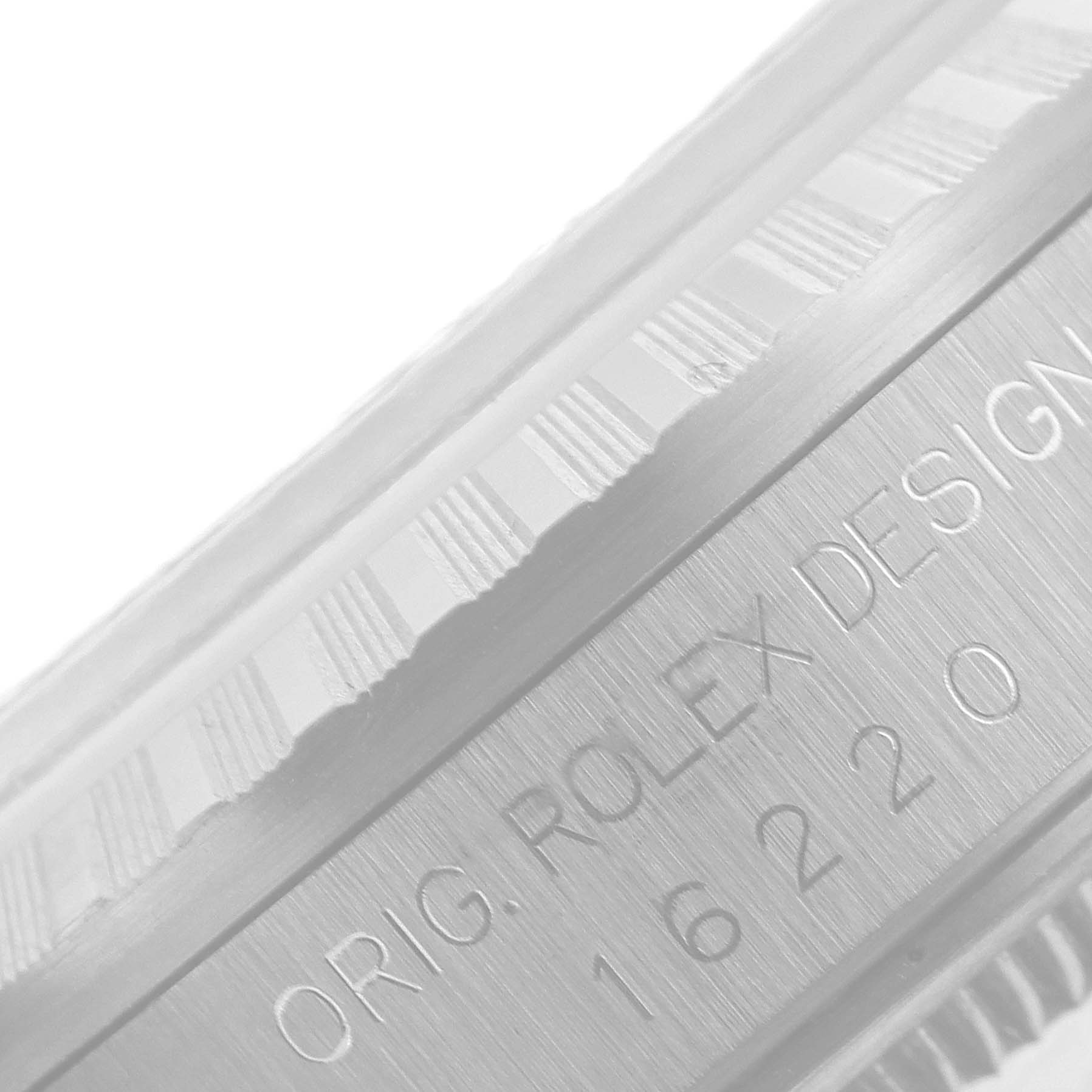 This image shows a close-up of the engraved text and part of the fluted bezel on a Rolex Datejust 16220 Men's Stainless Steel Silver Dial 16220 Men's Stainless Steel Silver Dial watch.