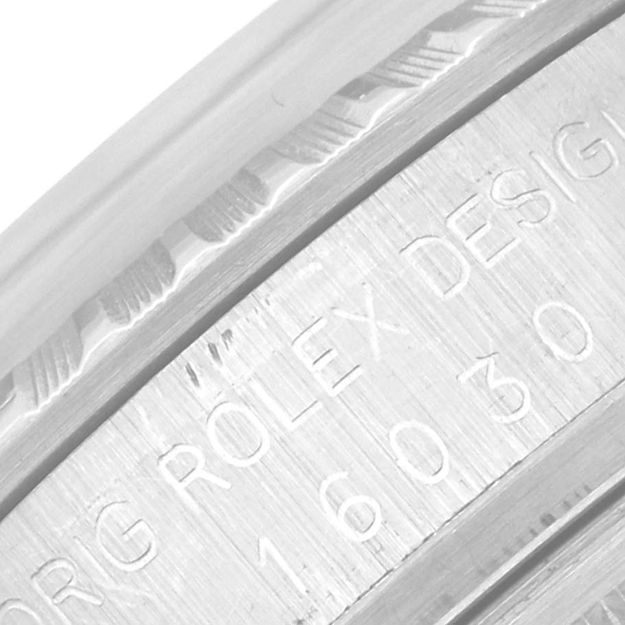 This close-up image shows the etched model number and "ORIG ROLEX DESIGN" engraving on the side of a Rolex Vintage Collection 16030 Men's Stainless Steel Silver Dial 16030 Men's Stainless Steel Silver Dial watch.