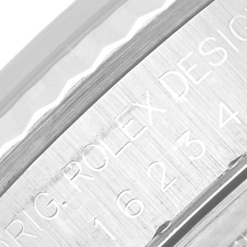 This image shows a close-up of the etched writing on the side of the case of a Rolex Datejust 16234 Men
s Stainless Steel Silver Dial 16234 Men
s Stainless Steel Silver Dial watch.