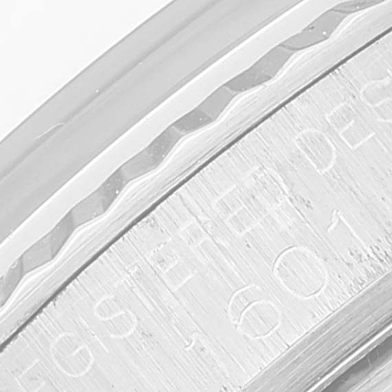 The image shows a close-up of the engraved edge of the bezel on a Rolex Vintage Collection 1601 Men
s Stainless Steel Black Dial 1601 Men
s Stainless Steel Black Dial model watch.