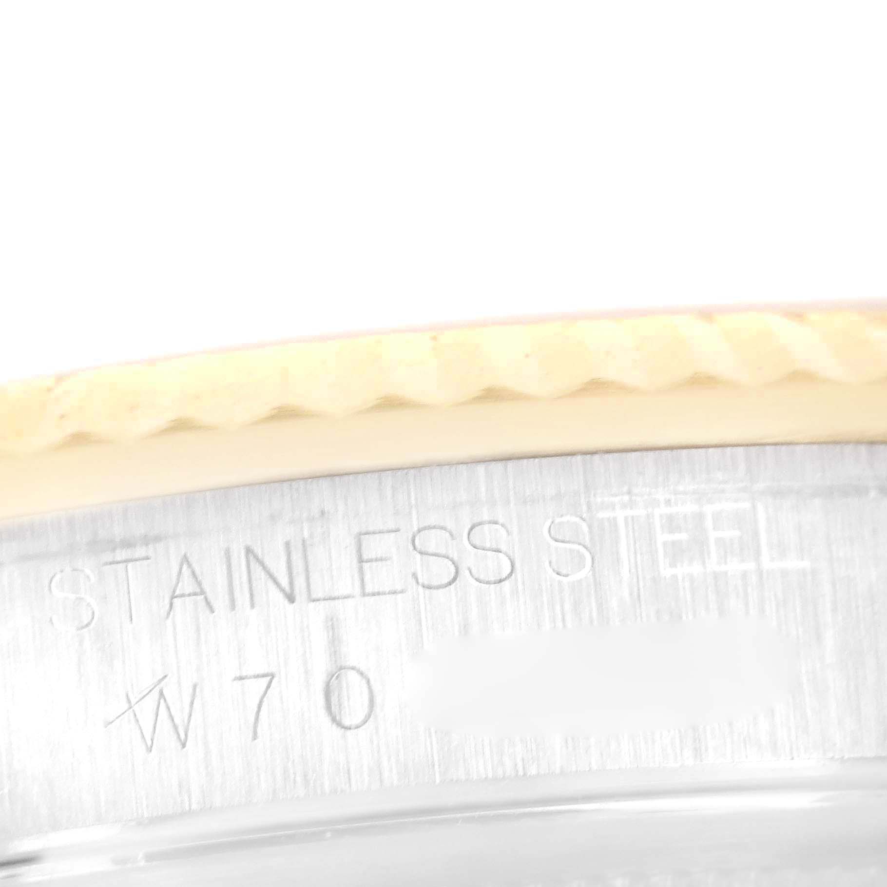 The image shows a close-up of the side engraving and fluted bezel of a Rolex Datejust 16233 Men's Steel and Gold (two tone) Champagne Dial 16233 Men's Steel and Gold (two tone) Champagne Dial watch, focusing on the "STAINLESS STEEL" text.