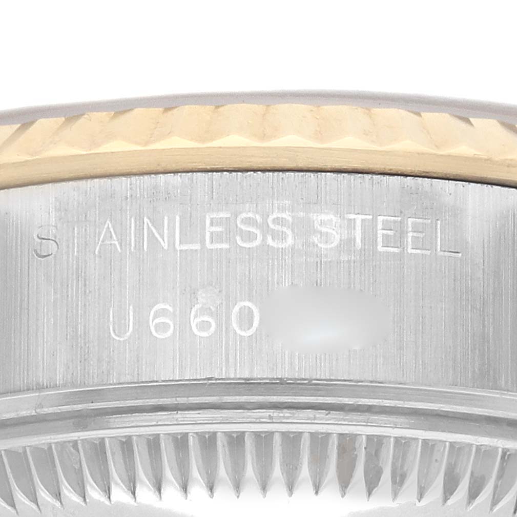 The image shows a close-up of the side of a Rolex Datejust 69173 Women's Steel and Gold (two tone) Champagne Dial 69173 Women's Steel and Gold (two tone) Champagne Dial watch, highlighting the bezel and engraved "stainless steel."