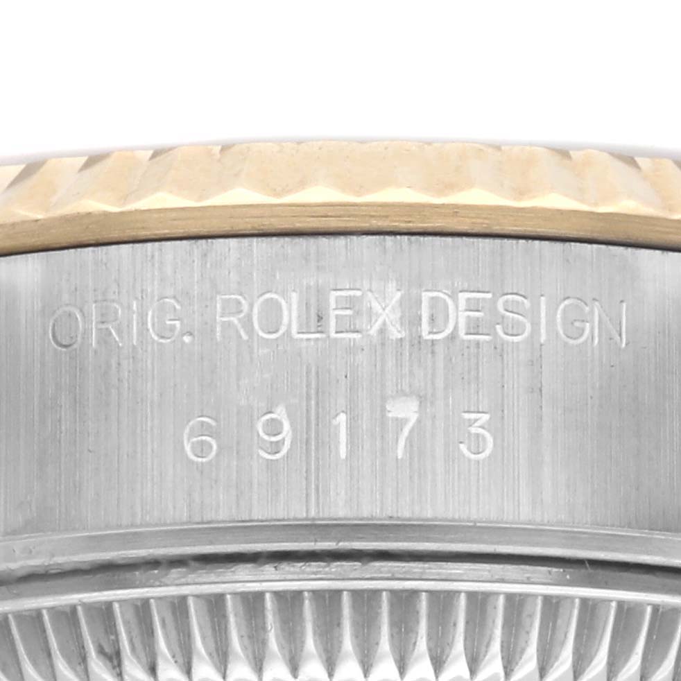 The image shows a close-up of the case side and part of the bezel of the Rolex Datejust 69173 Women's Steel and Gold (two tone) Champagne Dial 69173 Women's Steel and Gold (two tone) Champagne Dial, featuring engraving details.