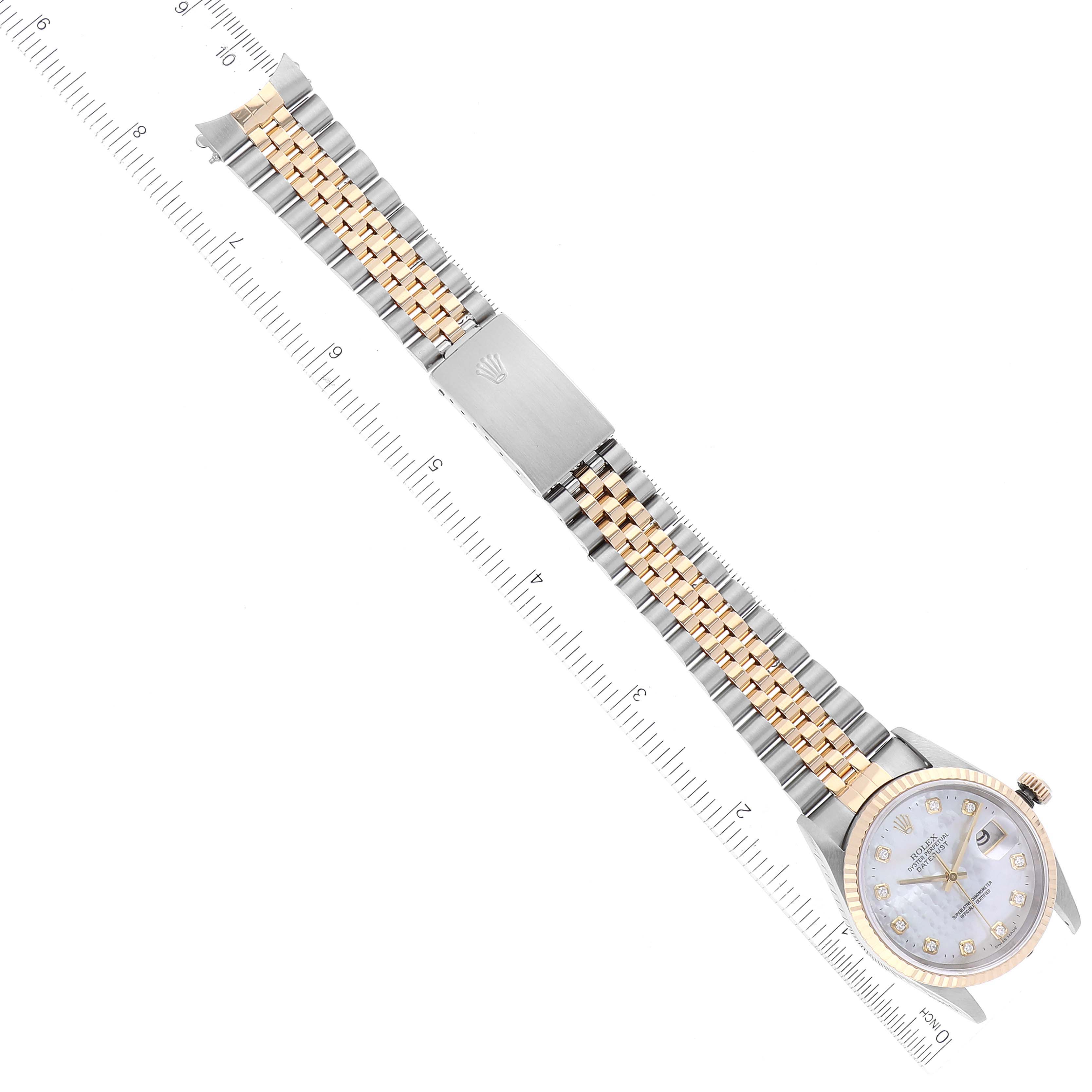 The image shows an overhead view of a Rolex Datejust 16233 Men's Steel and Gold (two tone) Mother of Pearl Dial 16233 Men's Steel and Gold (two tone) Mother of Pearl Dial watch lying flat with the bracelet fully extended alongside a ruler.