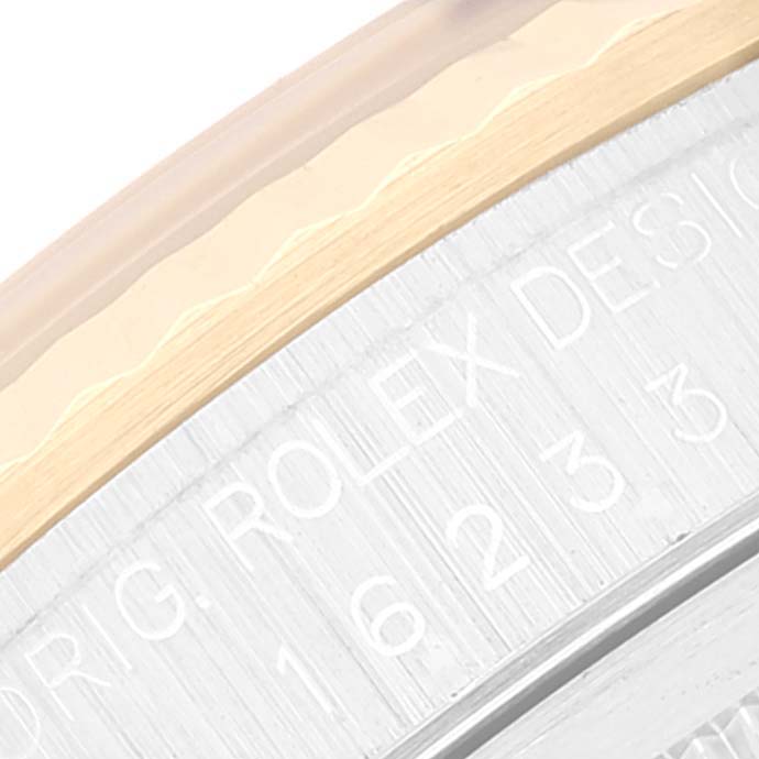 This close-up image shows part of the bezel and a portion of the engraved text on a Rolex Datejust 16233 Men's Steel and Gold (two tone) Mother of Pearl Dial 16233 Men's Steel and Gold (two tone) Mother of Pearl Dial watch.