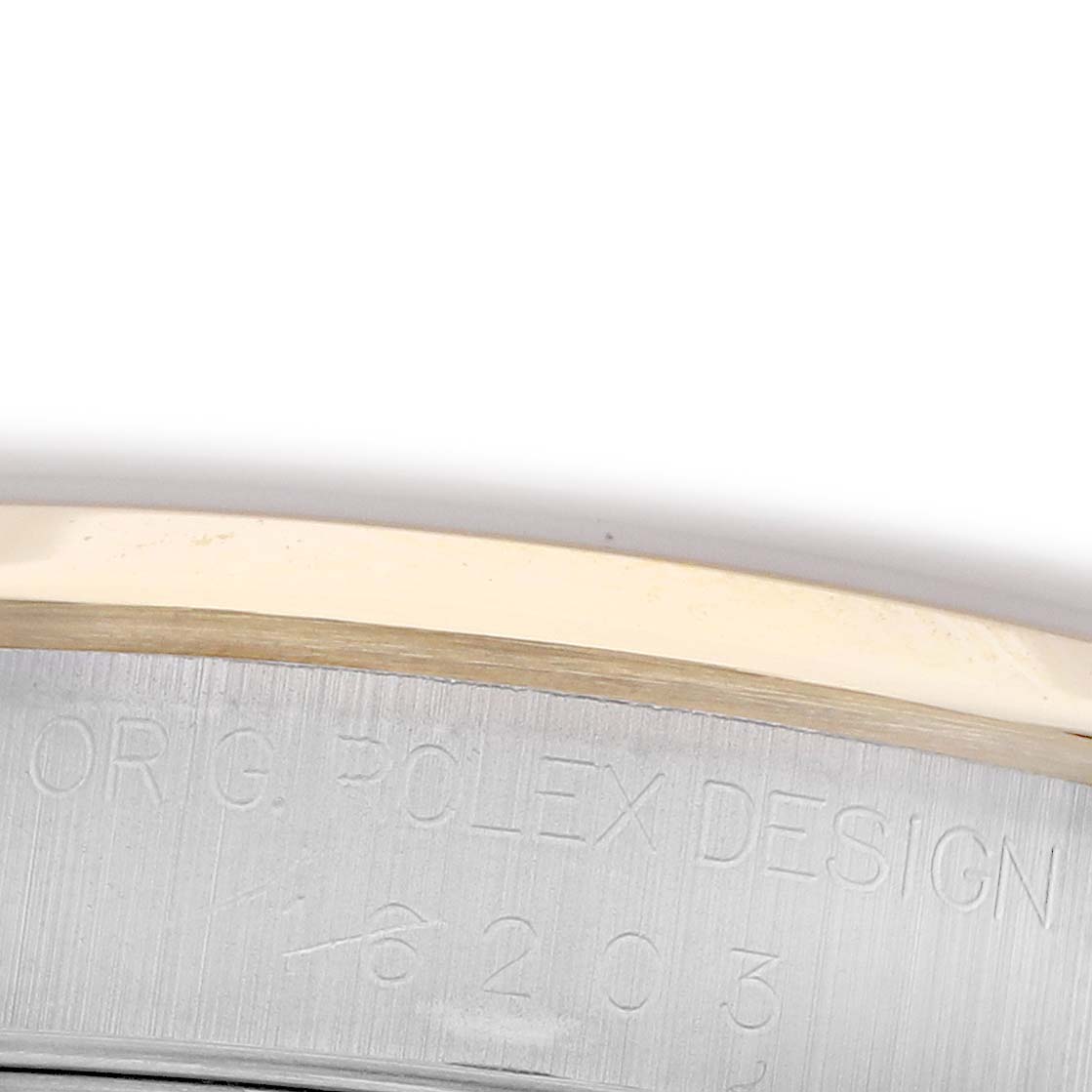 The image shows the side of a Rolex Datejust 16203 Men's Steel and Gold (two tone) Grey Dial 16203 Men's Steel and Gold (two tone) Grey Dial watch with engraved text on the casing.