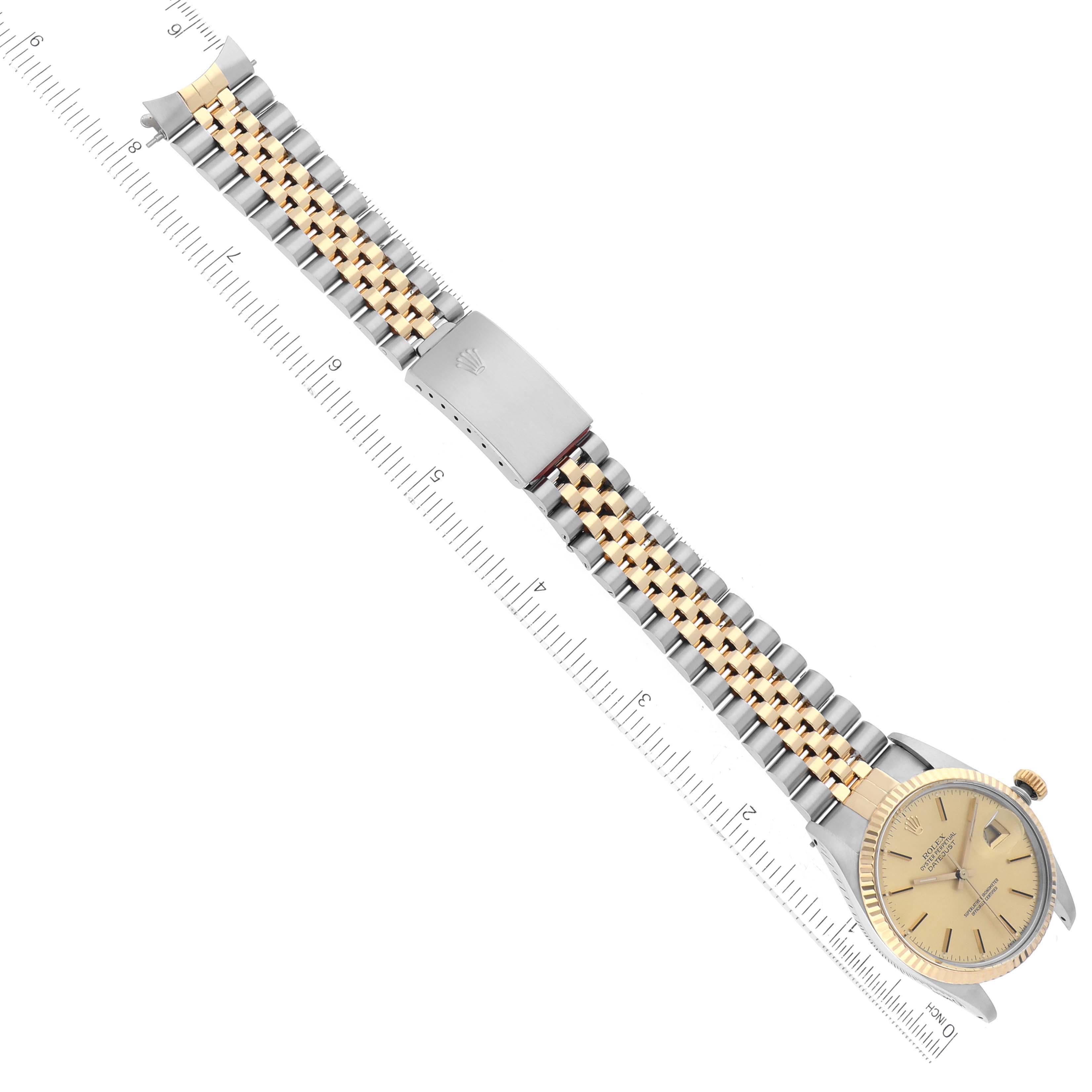 The Rolex Vintage Collection 16013 Men's Steel and Gold (two tone) Champagne Dial 16013 Men's Steel and Gold (two tone) Champagne Dial watch is shown from a top-down angle, featuring the face, dual-tone bracelet, and clasp, alongside a ruler.