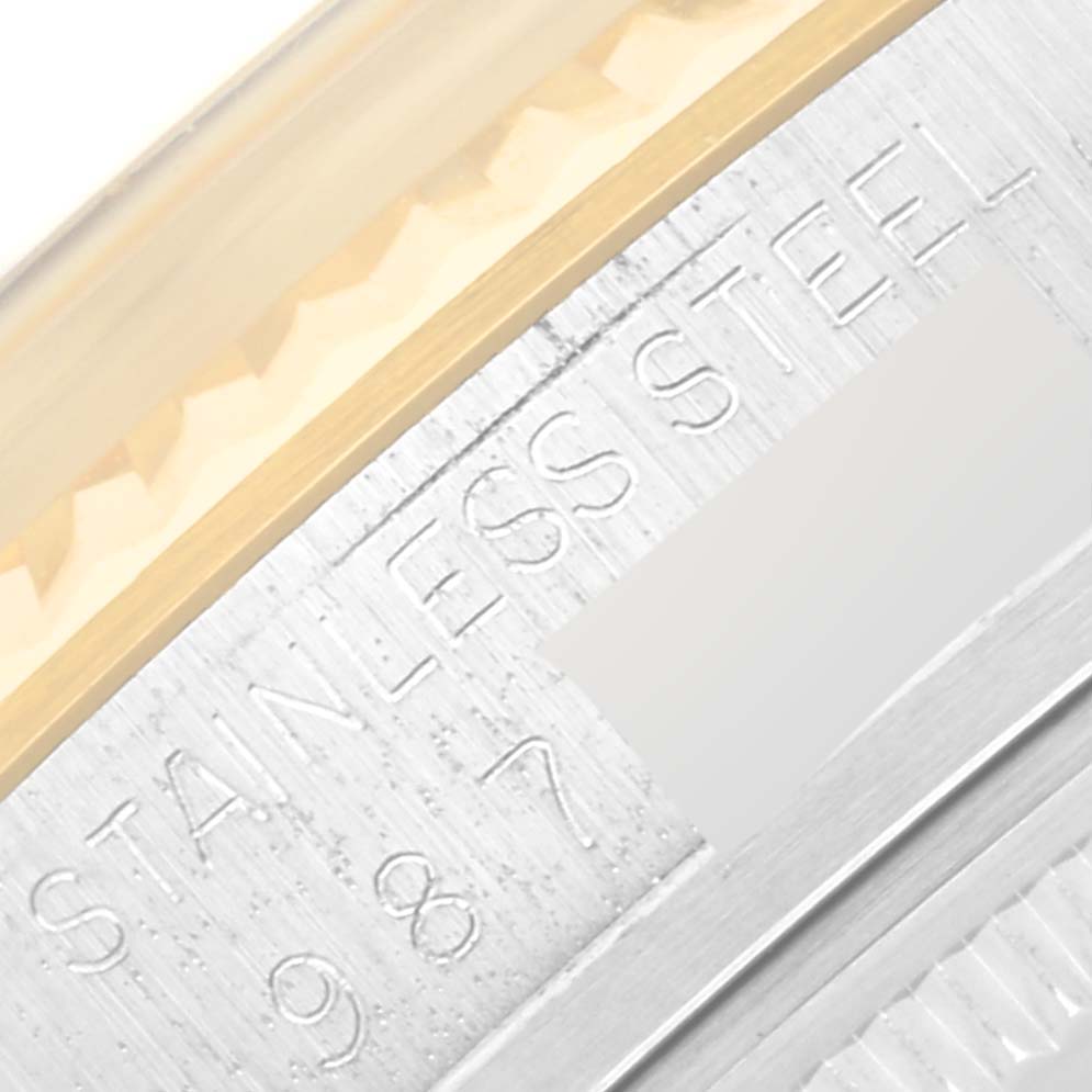 The close-up image shows the stainless steel bezel edge and part of the case of a Vintage Collection model by Rolex.