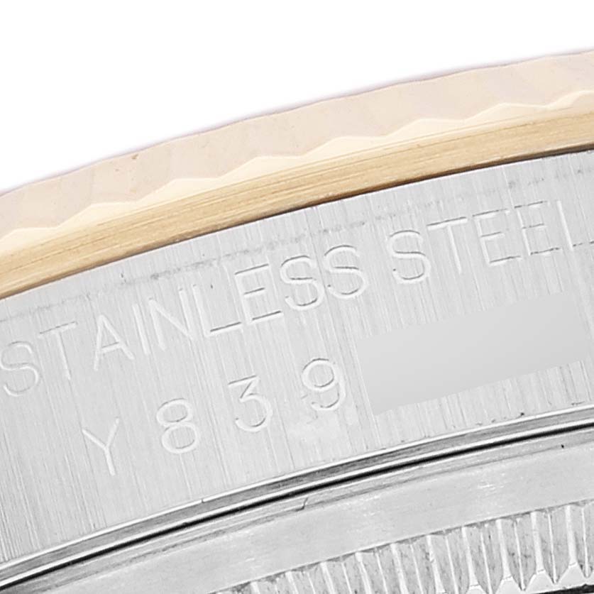 This close-up image shows the engraved serial number and stainless steel bezel of a Rolex Datejust 16233 Men's Steel and Gold (two tone) White Dial 16233 Men's Steel and Gold (two tone) White Dial watch.