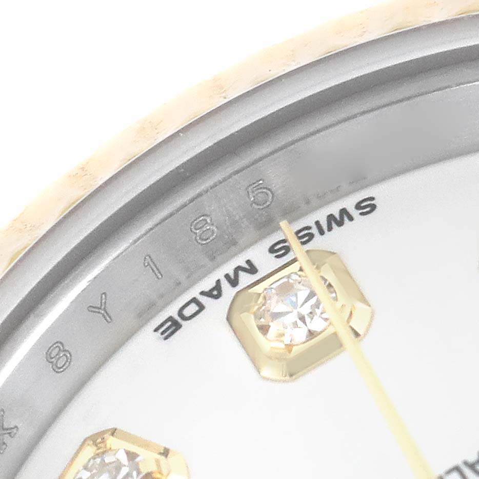 The image shows a close-up of the 5 o'clock marker with diamond detail and part of the bezel of a Rolex Datejust 179173 Women's Steel and Gold (two tone) White Dial 179173 Women's Steel and Gold (two tone) White Dial watch.