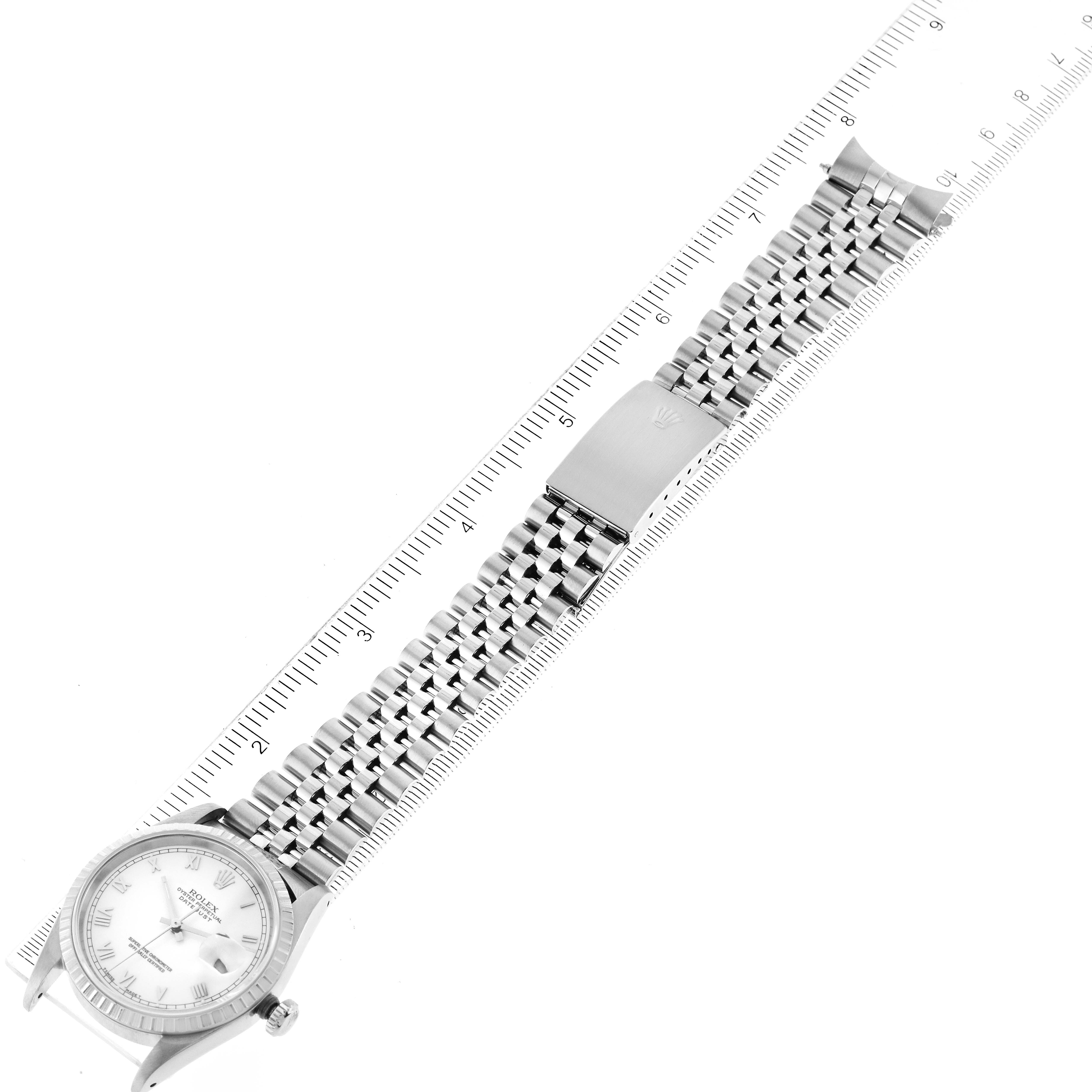 This image shows a Rolex Datejust 16220 Men's Stainless Steel White Dial 16220 Men's Stainless Steel White Dial watch from an overhead angle, highlighting the full watch and metal bracelet alongside a ruler.