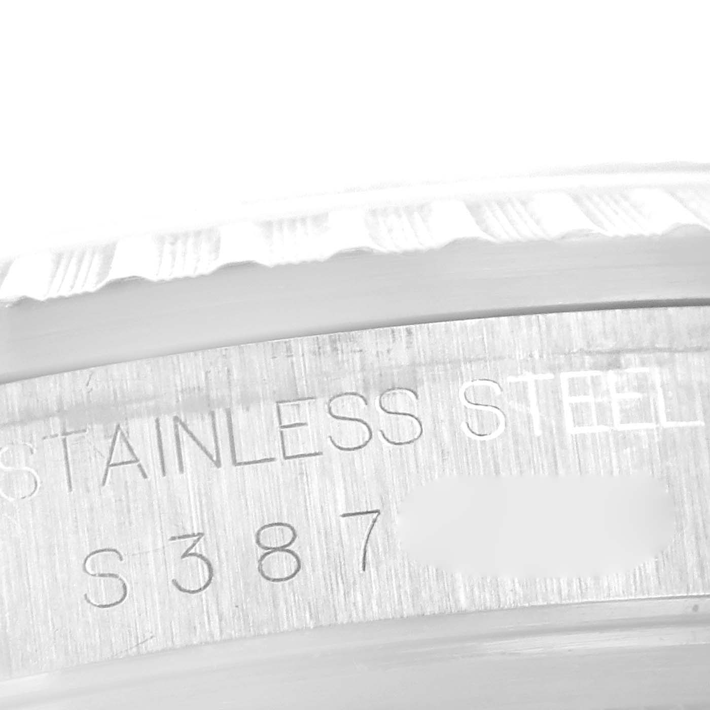 This close-up image of a Rolex Datejust 16220 Men's Stainless Steel White Dial 16220 Men's Stainless Steel White Dial watch shows part of the stainless steel case with engravings.