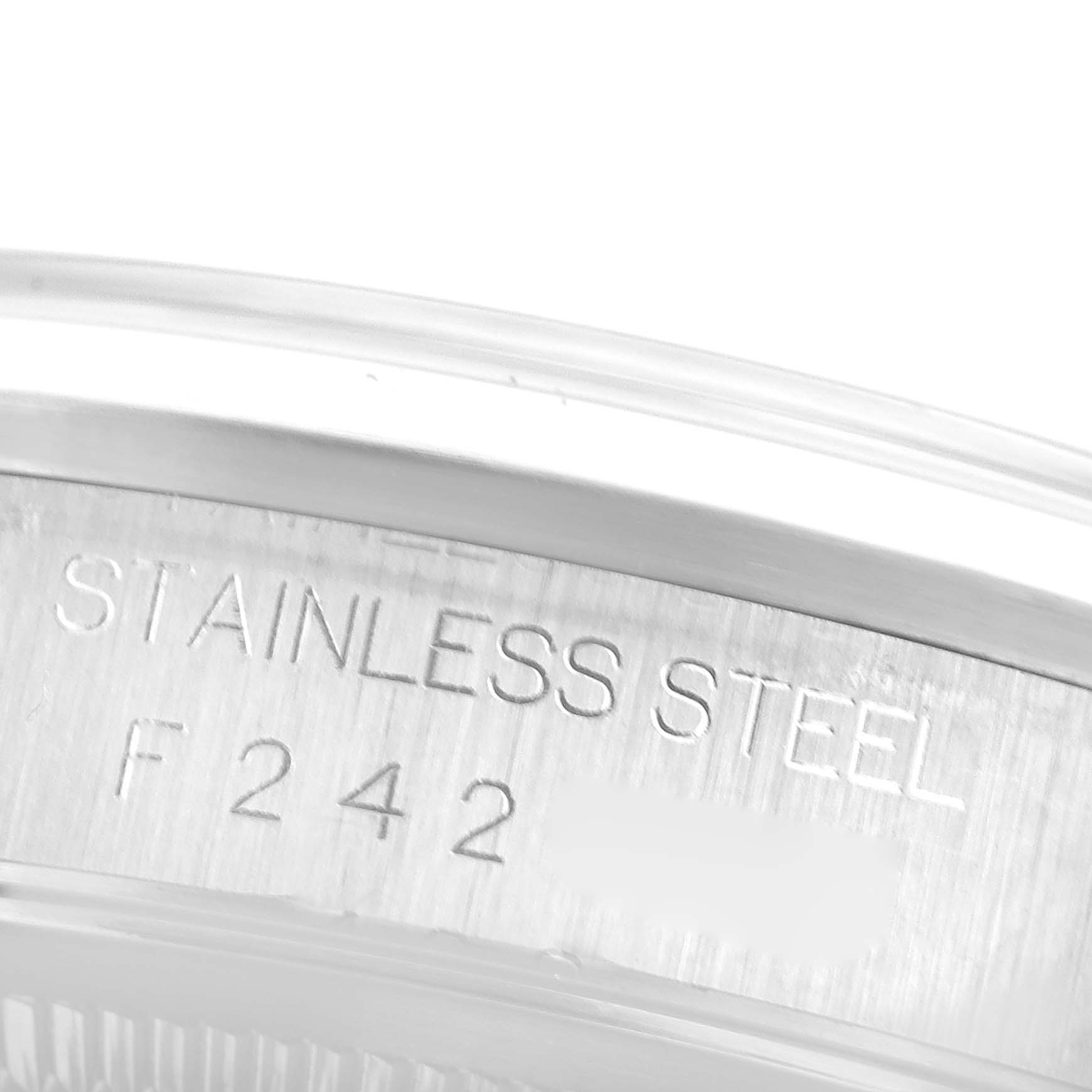This image shows a close-up of the stainless steel casing of a Rolex Datejust 16200 Men's Stainless Steel White Dial 16200 Men's Stainless Steel White Dial model watch, including engraved serial numbers.