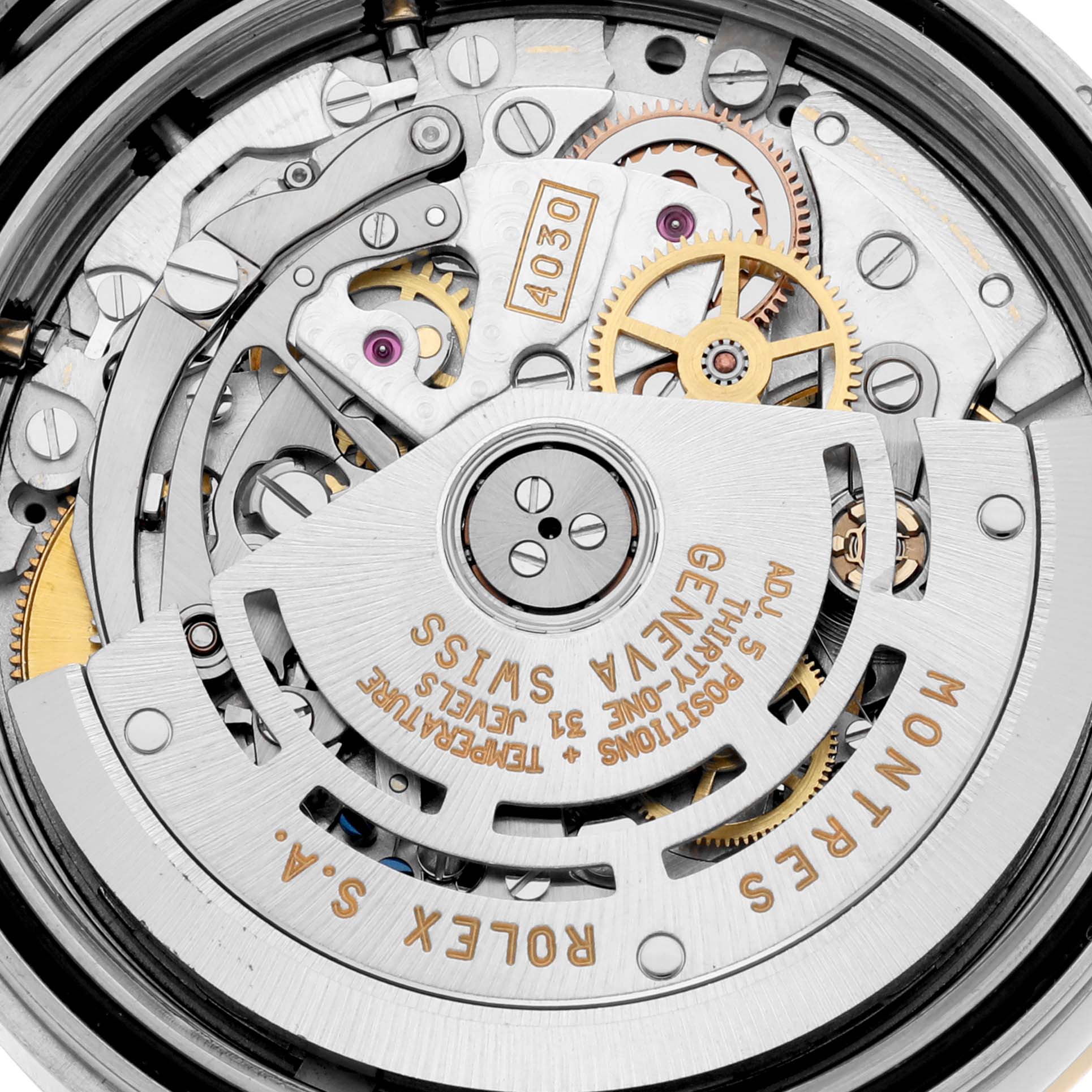 The image shows the movement of a Rolex Daytona 16523 Men's Steel and Gold (two tone) Black Dial watch, featuring gears, jewels, and the rotor from a top-down angle.