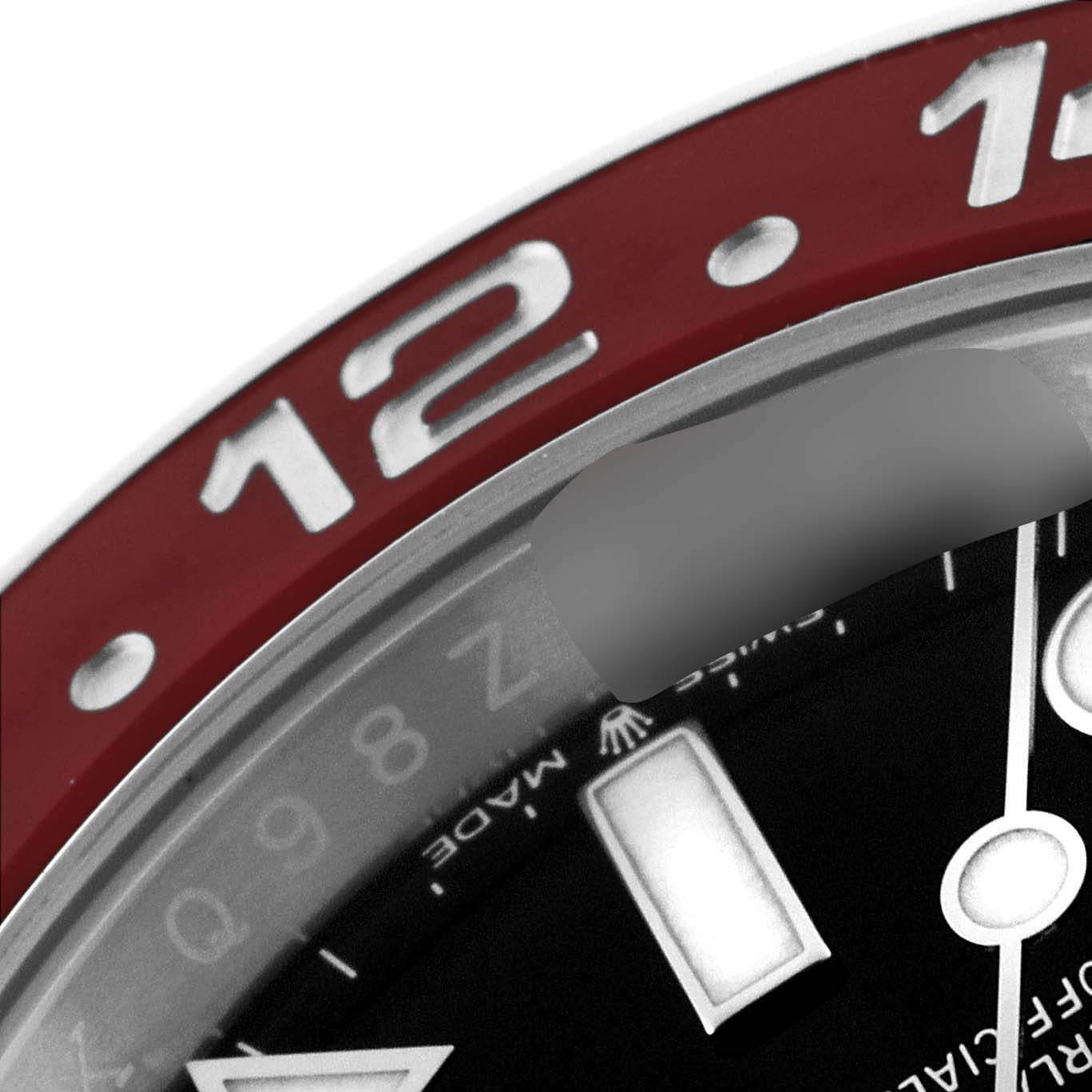 The image shows a close-up of the bezel and part of the dial of a Rolex GMT-Master 126710 Men
s Stainless Steel Black Dial 126710 Men
s Stainless Steel Black Dial watch, focusing on the "12" marker.