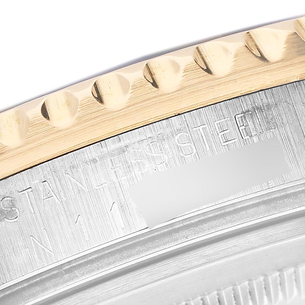 The image shows a close-up of the bezel and case back edge of a Rolex GMT-Master 16713LN Men's Steel and Gold (two tone) Black Dial 16713LN Men's Steel and Gold (two tone) Black Dial, highlighting the material and detailing.