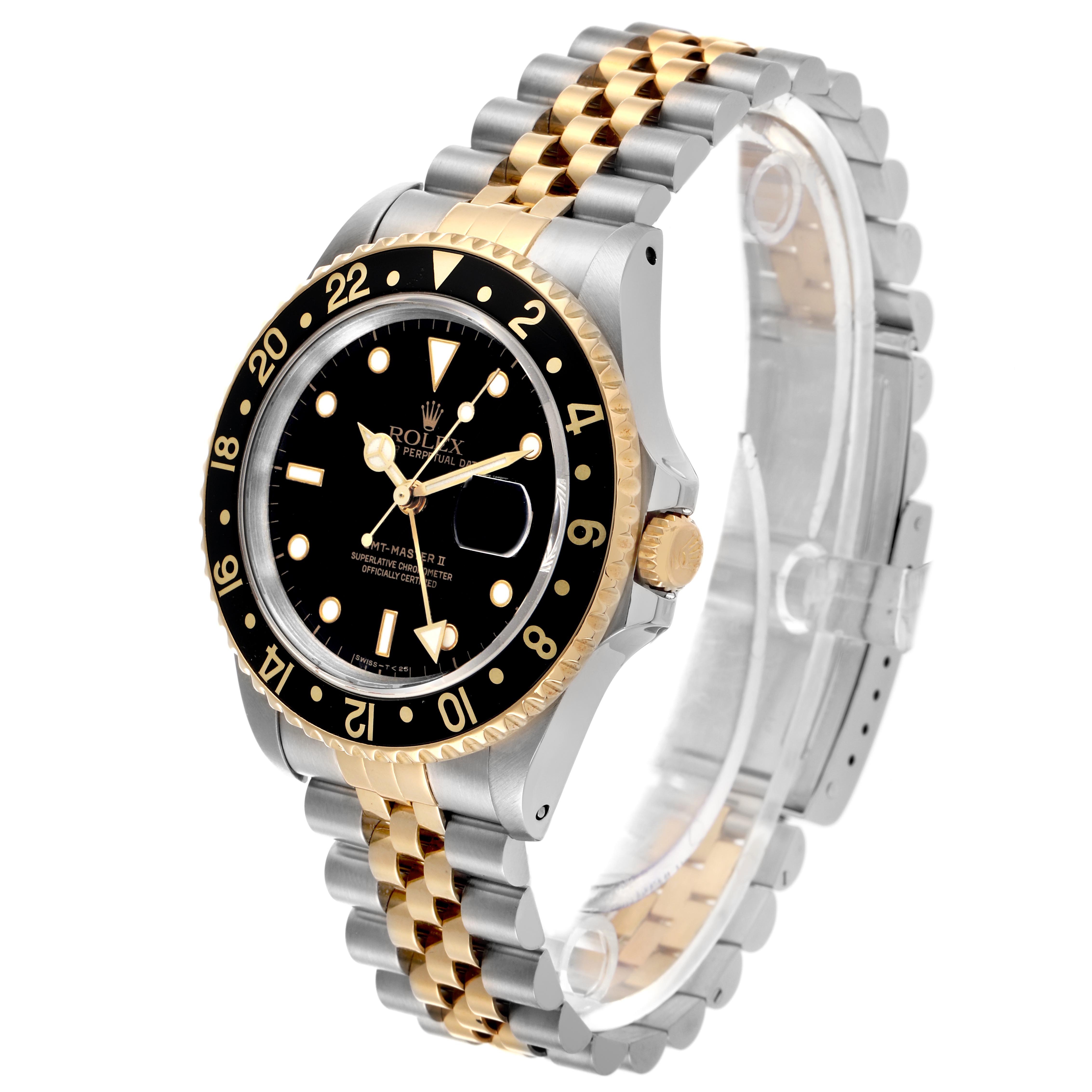 The Rolex GMT-Master 16713LN Men's Steel and Gold (two tone) Black Dial 16713LN Men's Steel and Gold (two tone) Black Dial watch is shown from a three-quarter angle, highlighting the bezel, dial, bracelet, and crown.