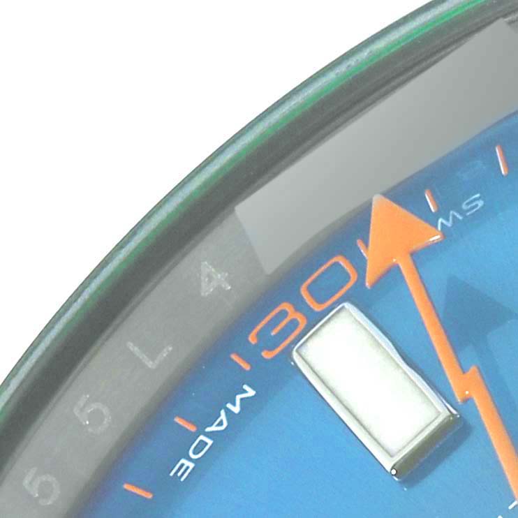 This close-up image of a Rolex Milgauss 116400GV Men's Stainless Steel Blue Dial 116400GV Men's Stainless Steel Blue Dial watch shows the minute markers, a luminescent hour marker, and the orange seconds hand.