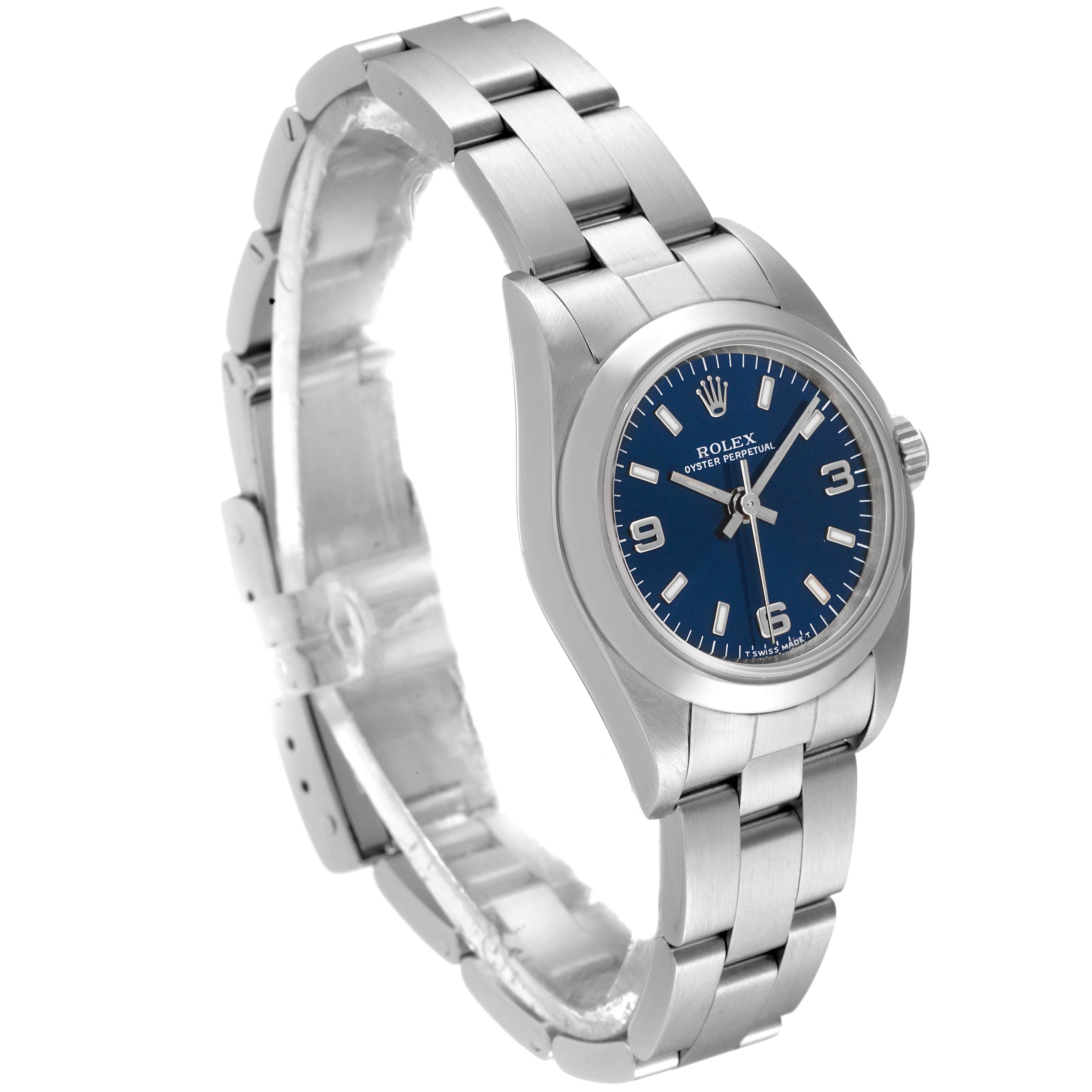 This image shows a Rolex Oyster Perpetual 76080 Women's Stainless Steel Blue Dial 76080 Women's Stainless Steel Blue Dial watch from a three-quarter angle, highlighting the face, bezel, and metal bracelet.