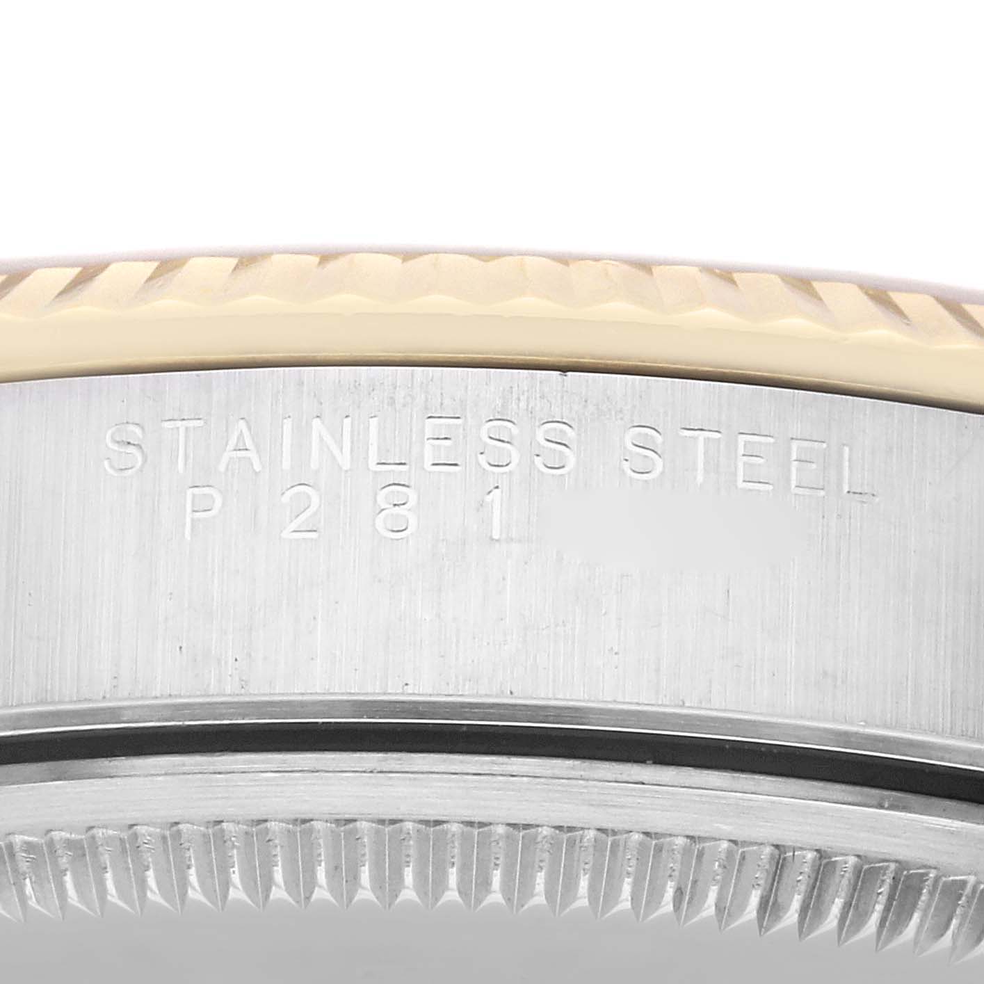 This close-up image shows the engraved side of the stainless steel casing of a Rolex Oyster Perpetual 14233 Men's Steel and Gold (two tone) Champagne Dial 14233 Men's Steel and Gold (two tone) Champagne Dial watch.