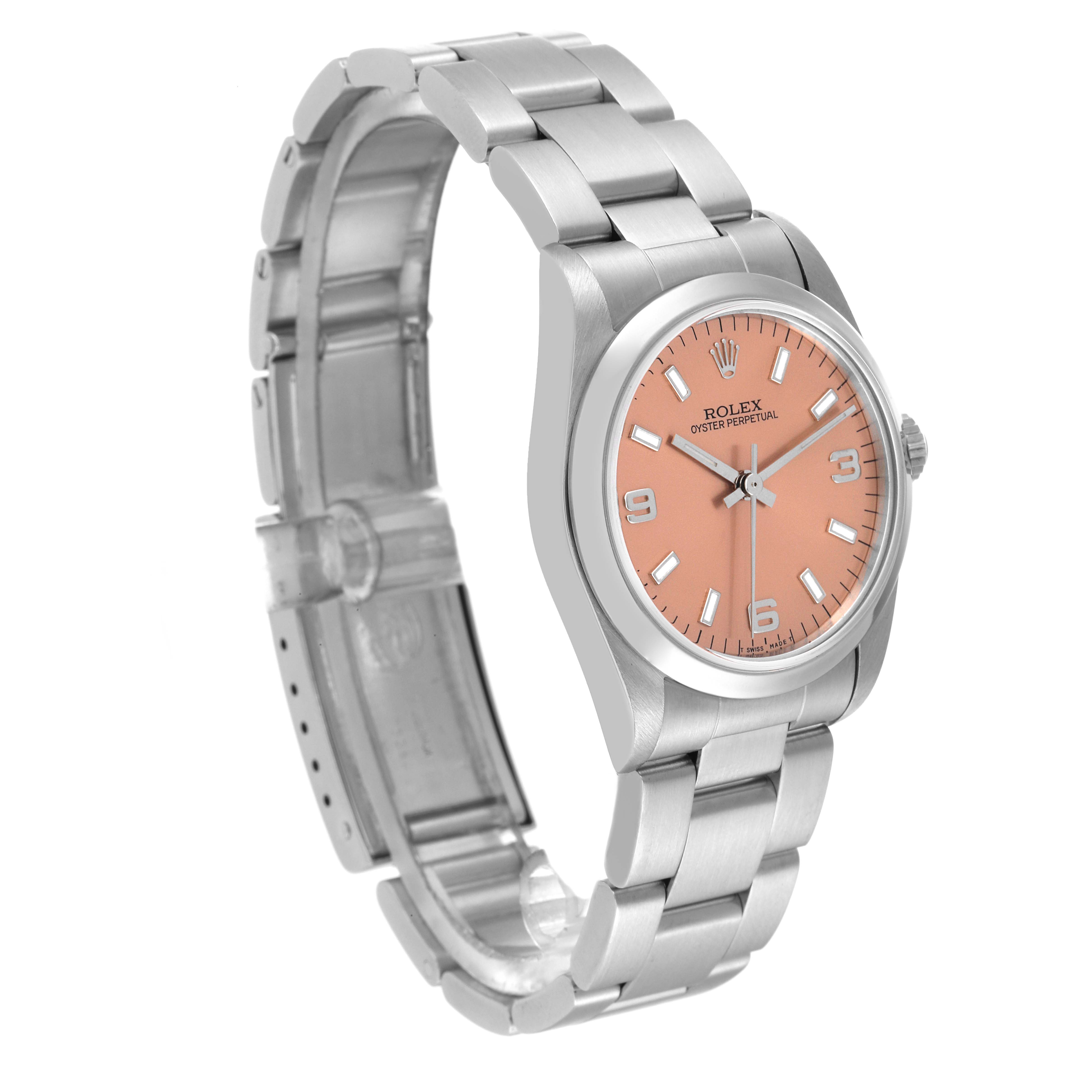 The image shows a side view of a Mid-Size Rolex Oyster Perpetual watch with a salmon-colored dial and an Oyster bracelet.