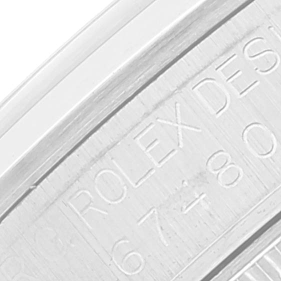 This image shows a close-up of the engraved text on the inner case of a Rolex Mid-Size 67480 Women
s Stainless Steel Pink Dial 67480 Women
s Stainless Steel Pink Dial watch.