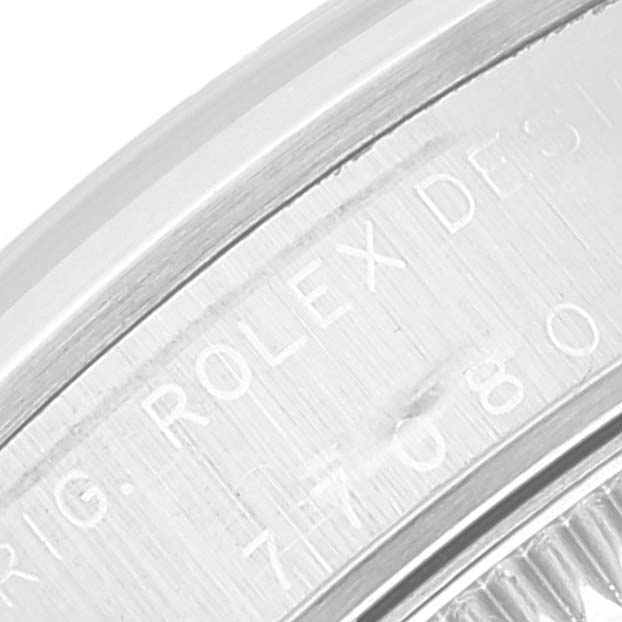 The image shows a close-up of the engravings on the side case of a mid-size Rolex watch.
