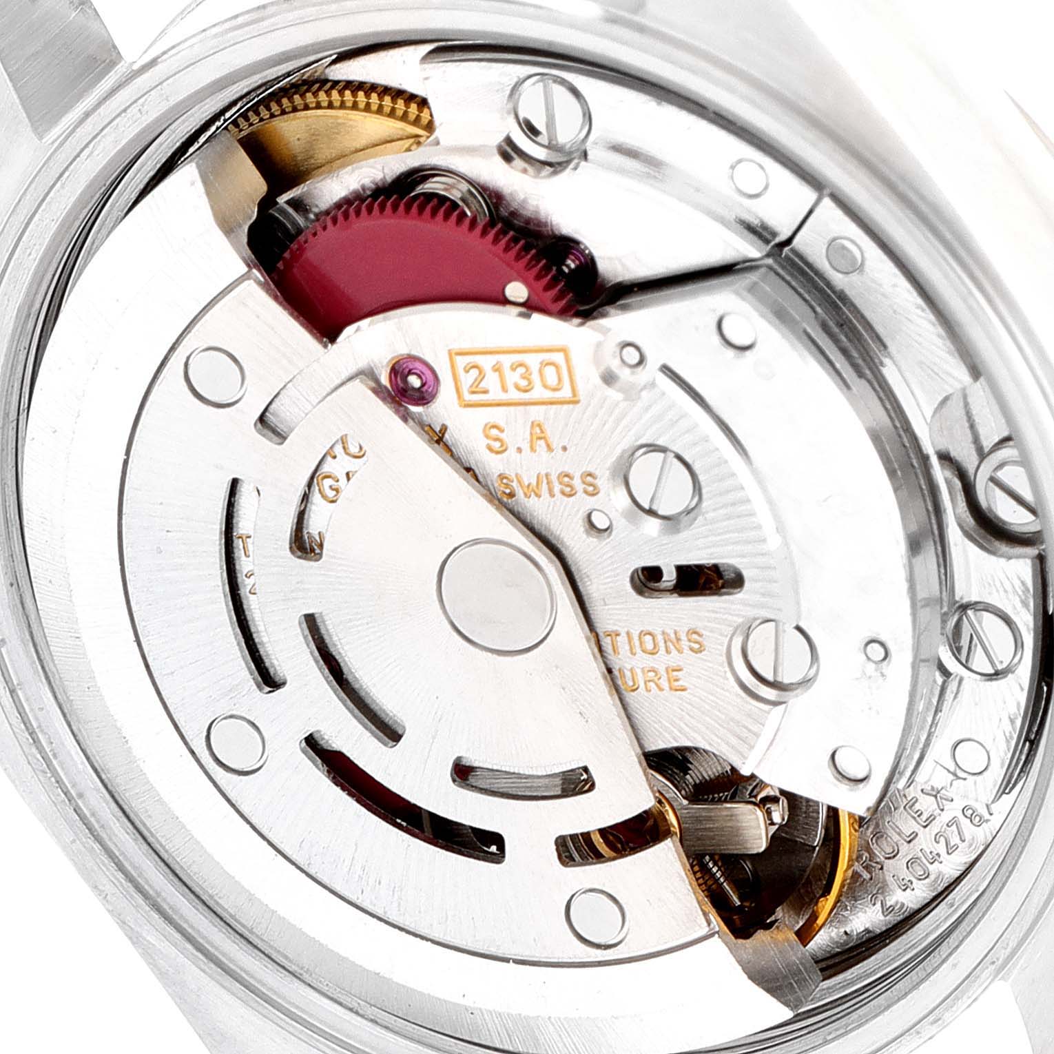 The image shows an up-close view of the movement mechanism of a Rolex Oyster Perpetual 67180 Women's Stainless Steel Black Dial 67180 Women's Stainless Steel Black Dial watch.