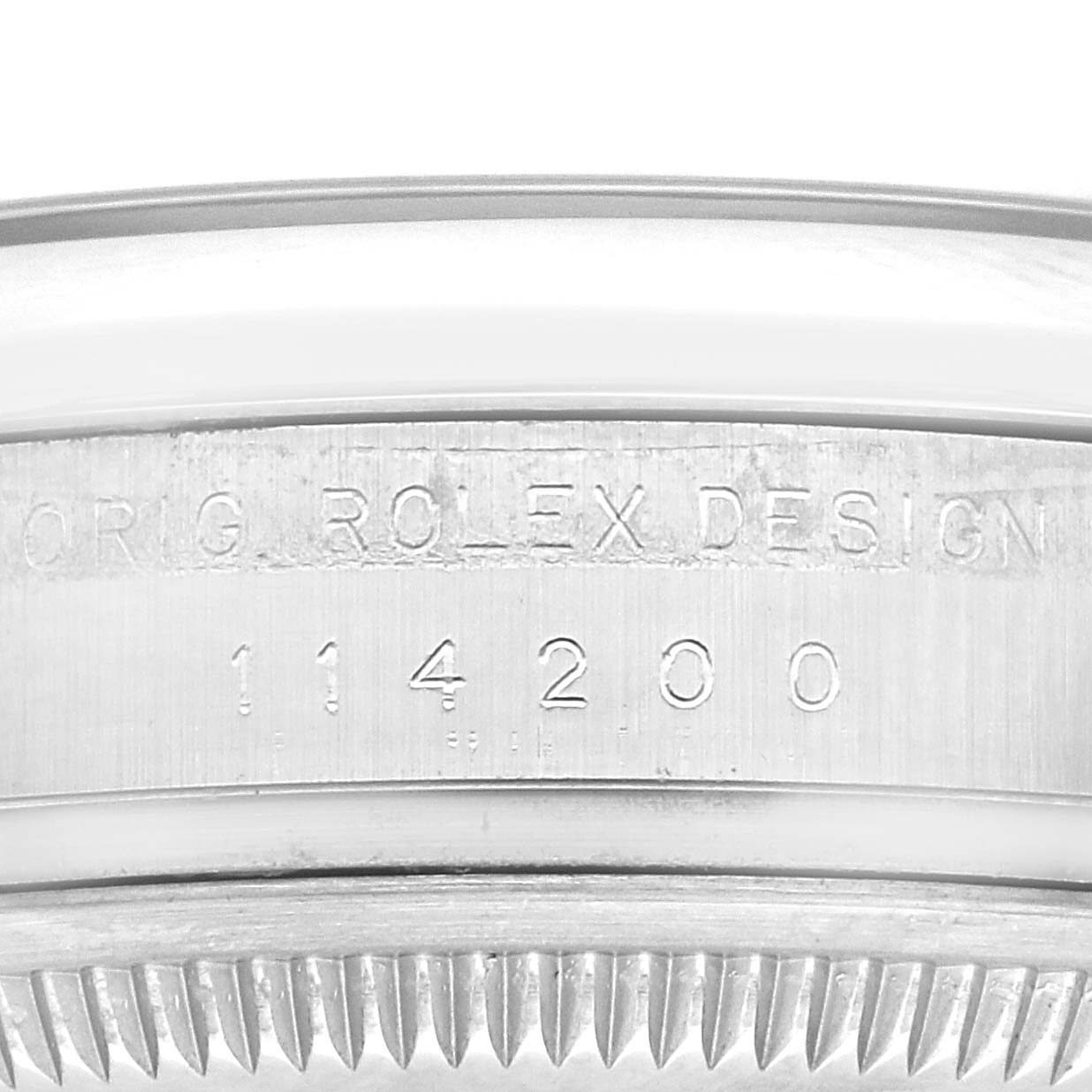 This image shows the side engraving of the case back of a Rolex Oyster Perpetual 114200 Men
s Stainless Steel Green Dial 114200 Men
s Stainless Steel Green Dial, including the model number "114200."