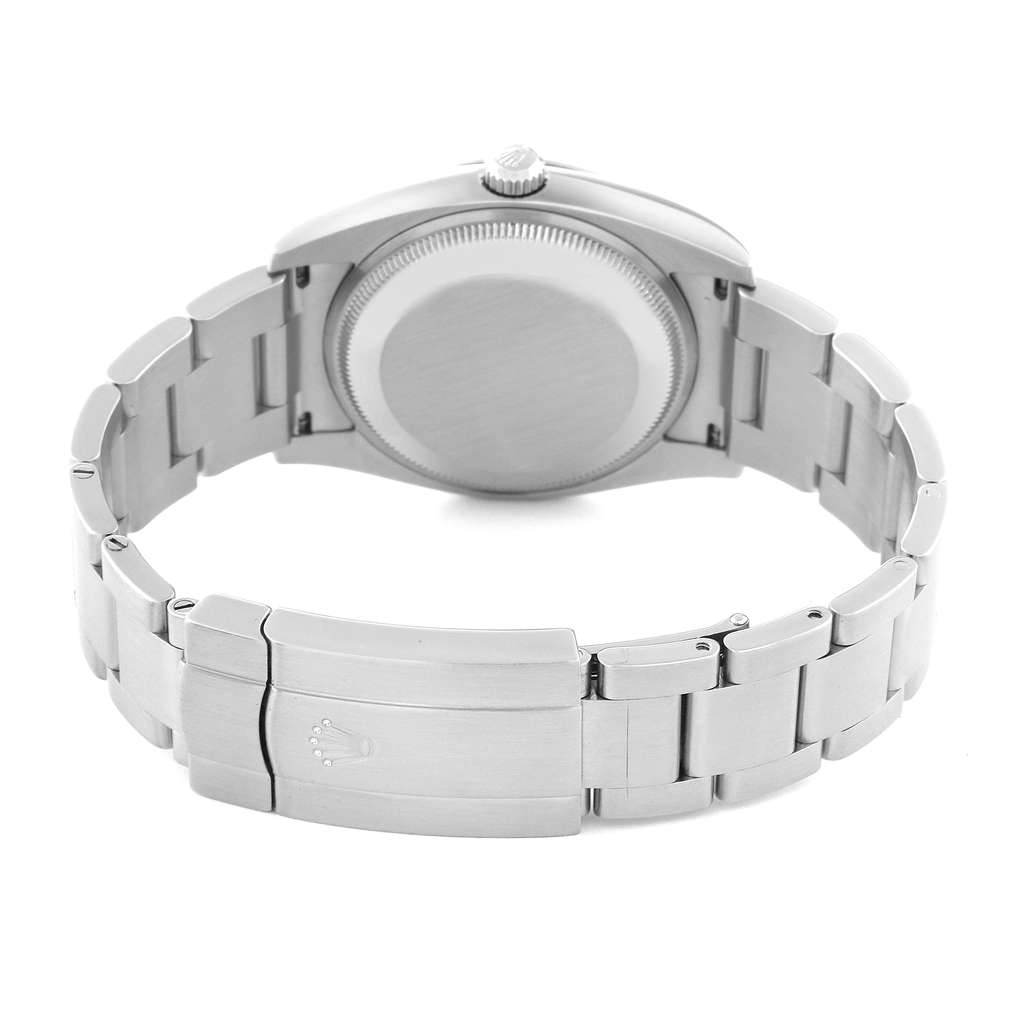 The image shows the rear side of a Rolex Oyster Perpetual 114200 Men
s Stainless Steel Green Dial 114200 Men
s Stainless Steel Green Dial watch, focusing on the case back and metal bracelet.