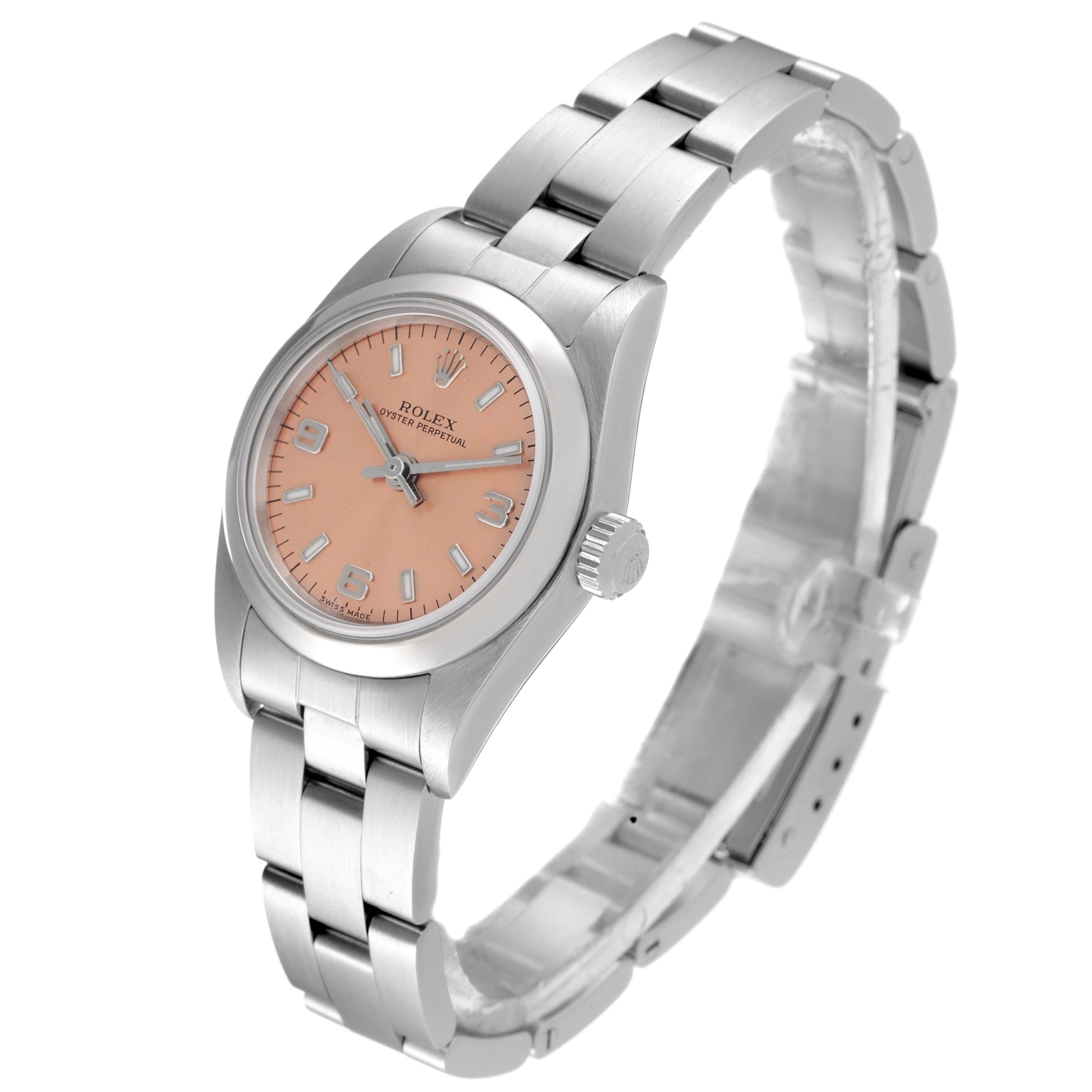 The image shows a Rolex Oyster Perpetual 76080 Women
s Stainless Steel Pink Dial 76080 Women
s Stainless Steel Pink Dial watch from a three-quarter angle, highlighting its peach dial and stainless steel bracelet.