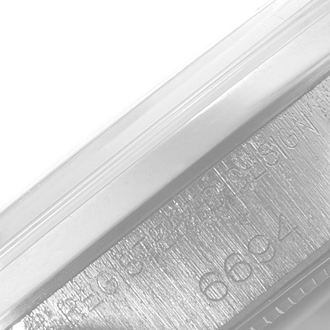 Close-up view of the serial number and inscription on the side case of a Rolex Date 6694 Men's Stainless Steel Silver Dial 6694 Men's Stainless Steel Silver Dial model watch.