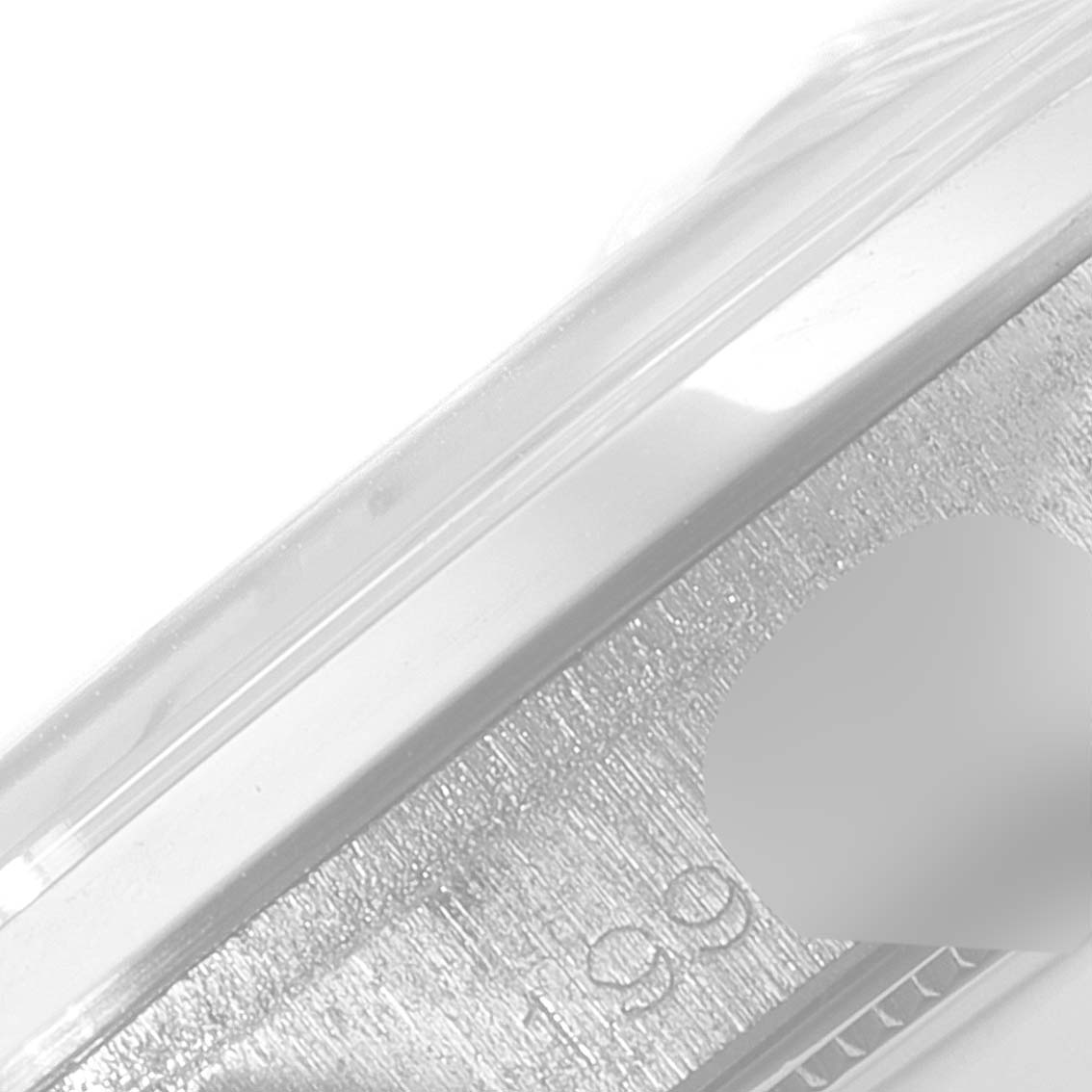 This close-up image shows a partial view of the metallic casing and possibly the edge of the crystal of a Rolex Date 6694 Men's Stainless Steel Silver Dial 6694 Men's Stainless Steel Silver Dial model watch.