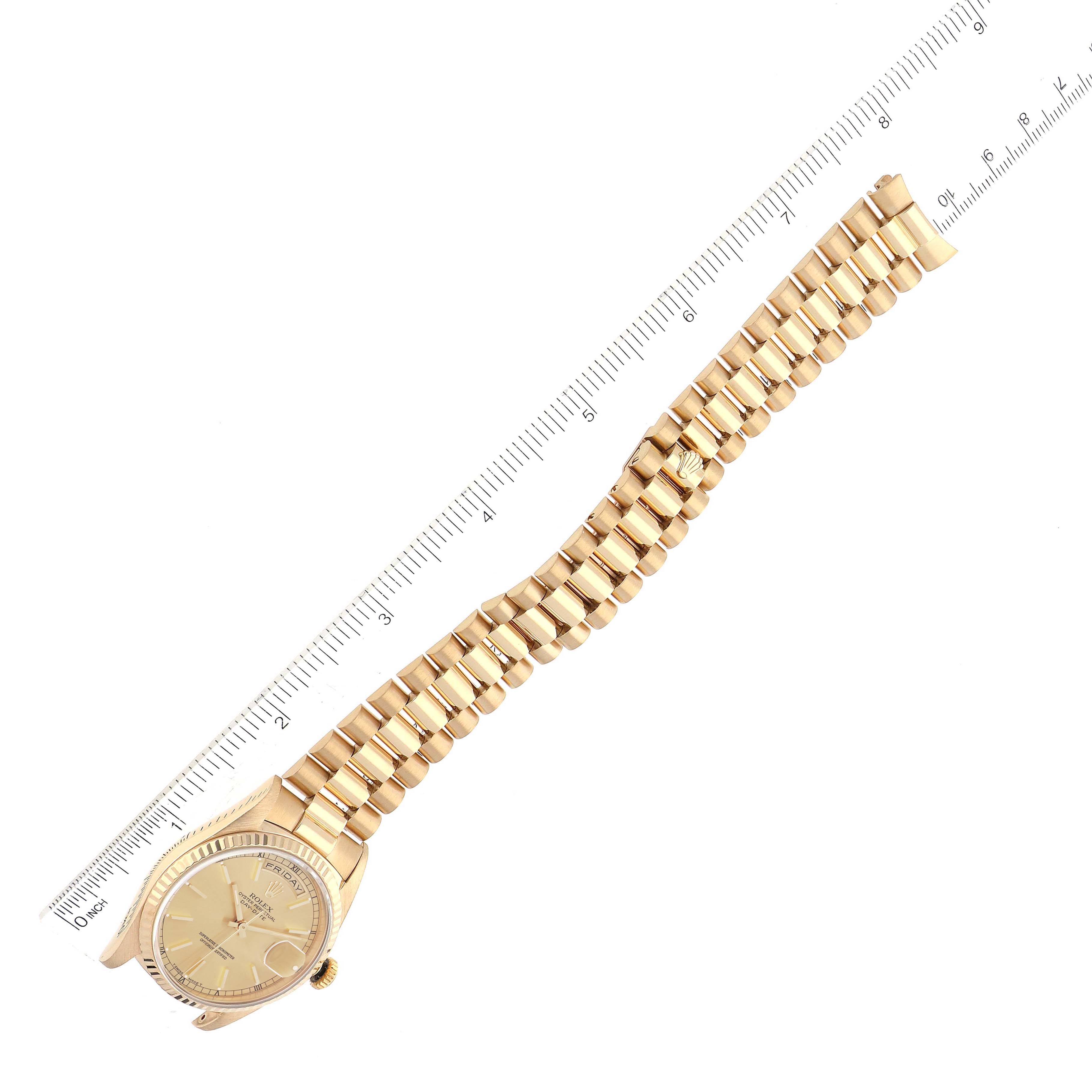 The image shows a Rolex President 18238 Men
s Yellow Gold Champagne Dial 18238 Men
s Yellow Gold Champagne Dial model watch laid flat with a ruler next to the band for measurement.