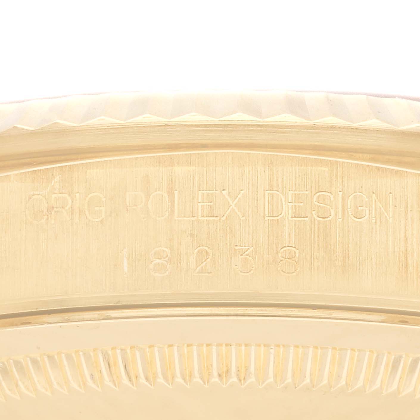 The image shows a close-up of the engraved side of a Rolex President 18238 Men
s Yellow Gold Champagne Dial 18238 Men
s Yellow Gold Champagne Dial model watch with the design number visible.