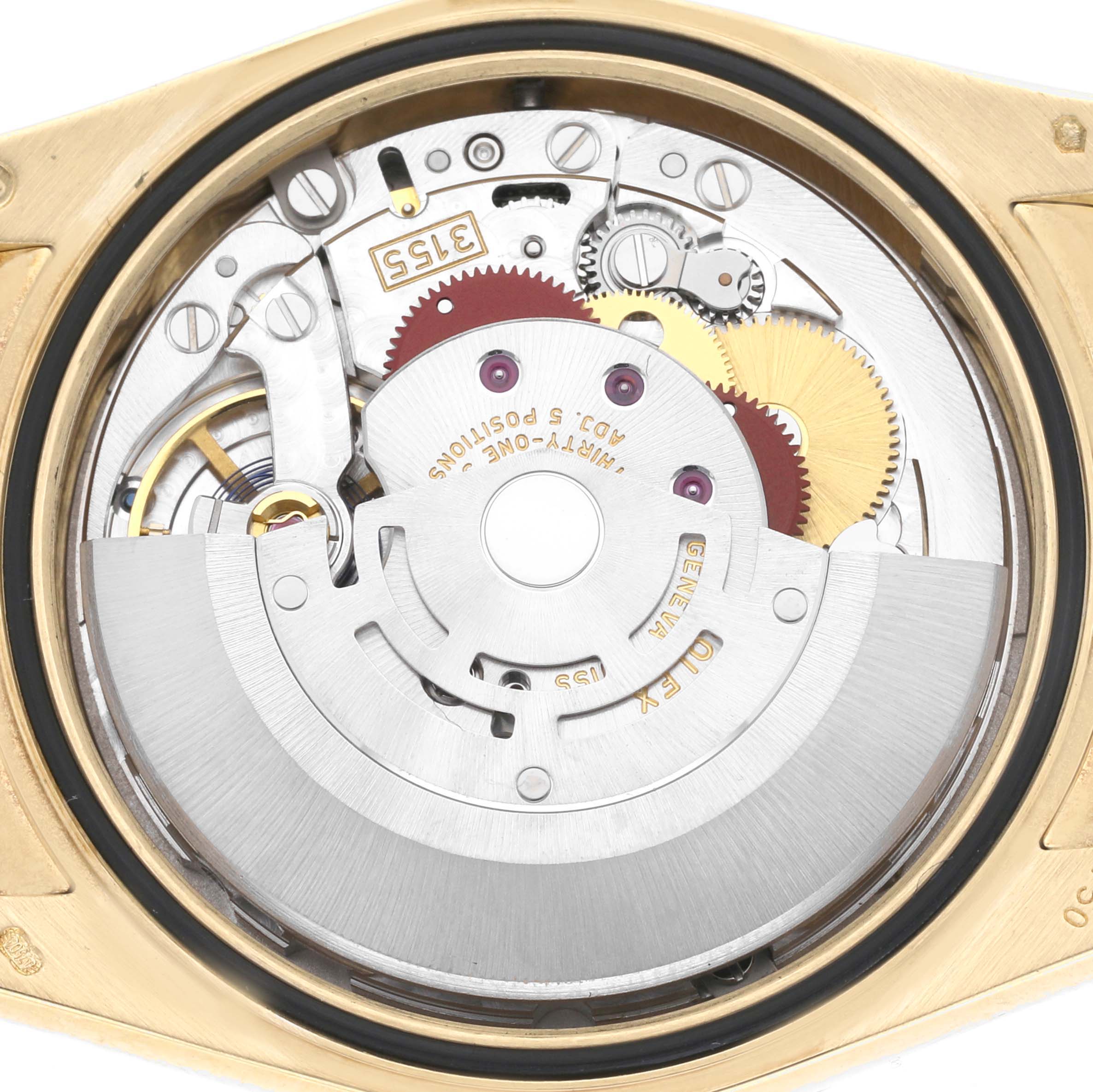 The image shows the internal mechanism of the Rolex President 118138 Men's Yellow Gold Green Dial watch from a top-down angle, highlighting gears and components.