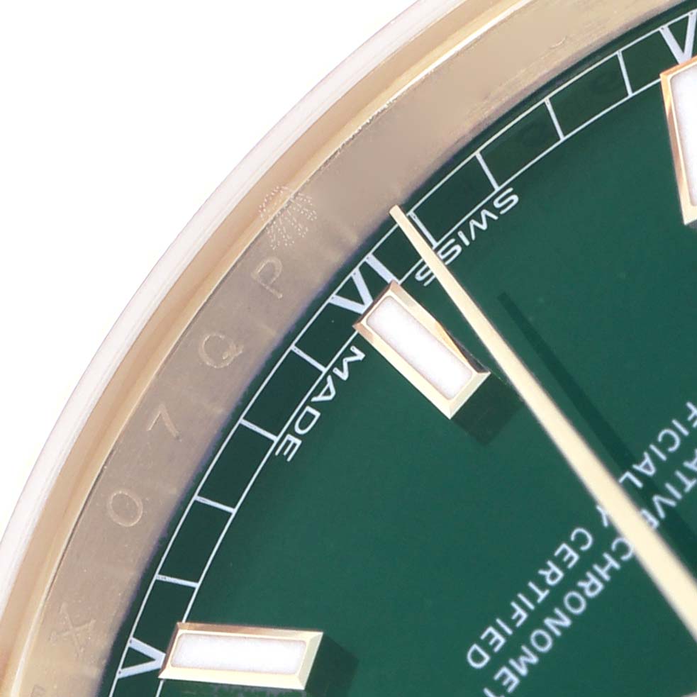 The image shows a close-up of the Rolex President 118138 Men's Yellow Gold Green Dial watch face, highlighting the hour markers and part of the dial with a green background.