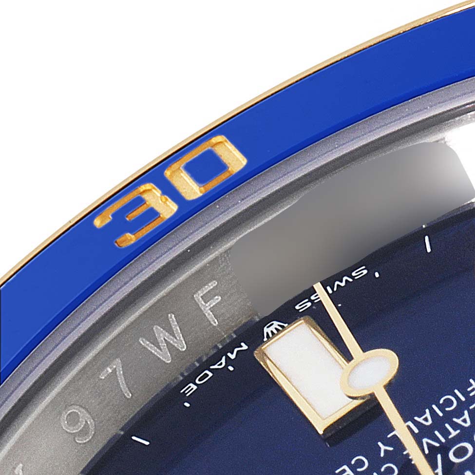 The image shows a close-up of the bezel and part of the dial of a Rolex Submariner 126613 Men's Steel and Gold (two tone) Blue Dial 126613 Men's Steel and Gold (two tone) Blue Dial watch.