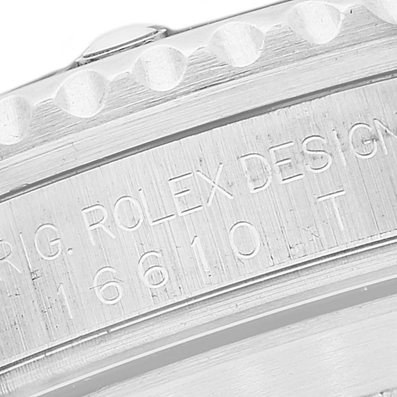 The image shows a close-up of the engraved edge and casing of a Rolex Submariner 16610T Men
s Stainless Steel Black Dial 16610T Men
s Stainless Steel Black Dial watch.