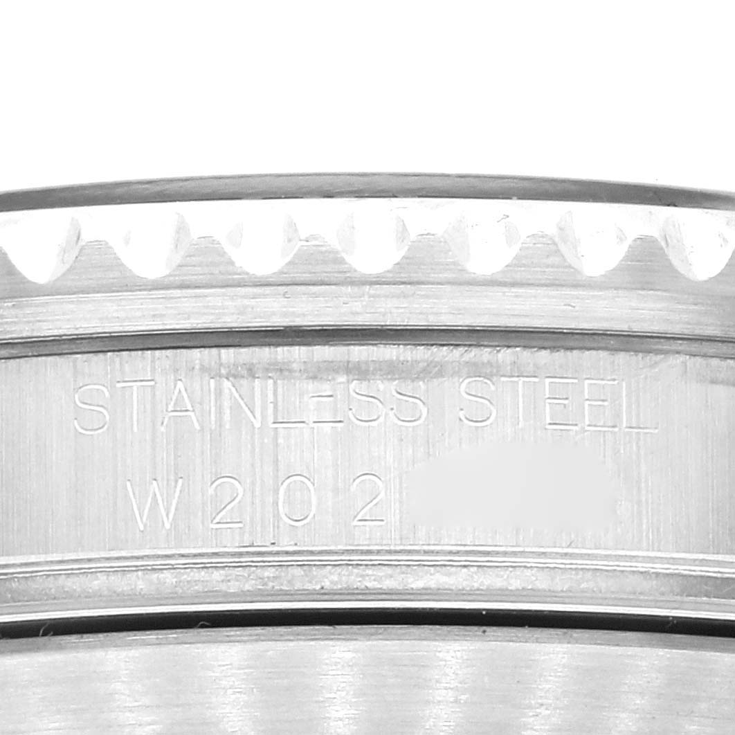 The image shows a close-up of the case back and bezel teeth of a Rolex Submariner 16610 Men
s Stainless Steel Black Dial 16610 Men
s Stainless Steel Black Dial, highlighting the "Stainless Steel" engraving.